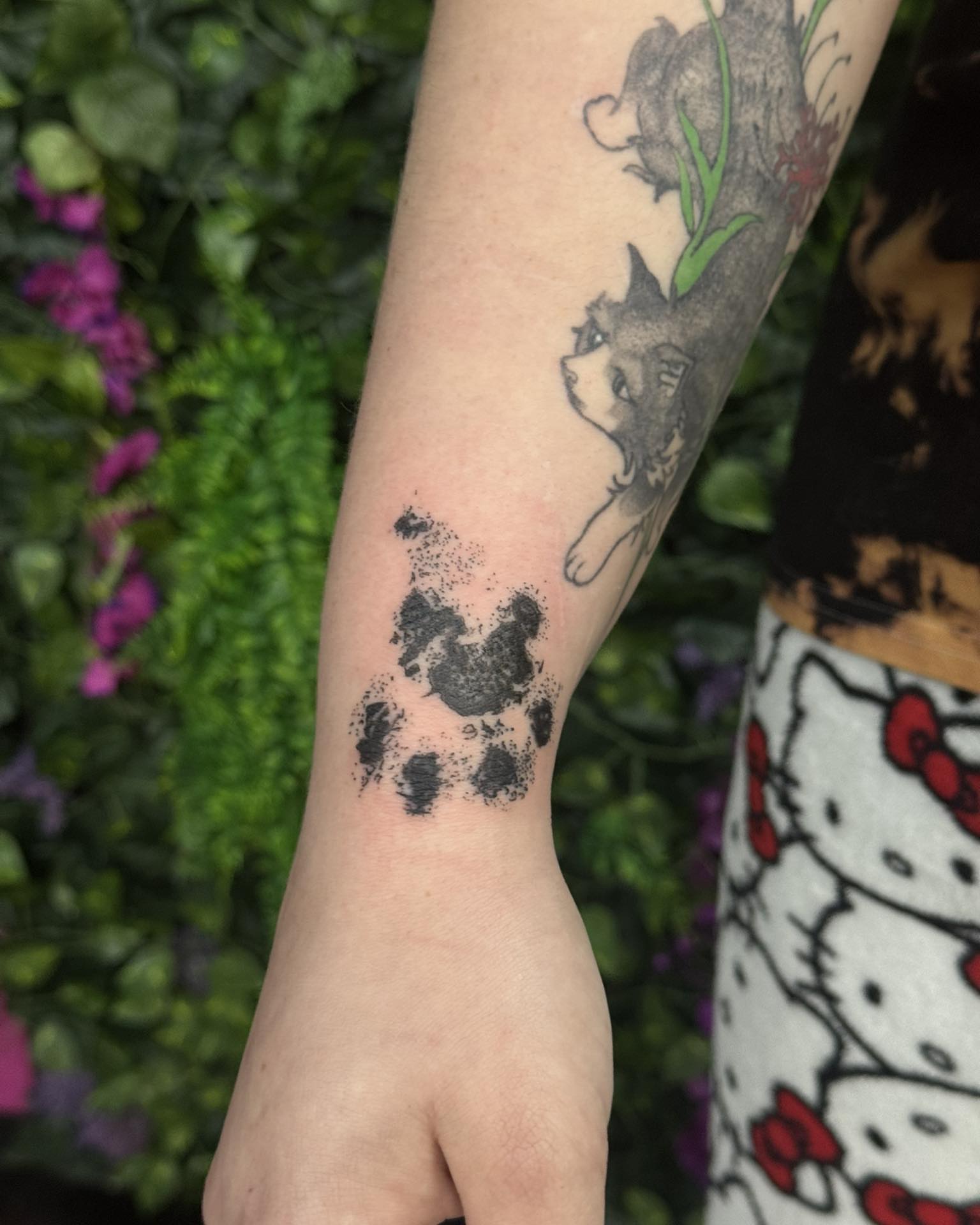 Dog paw print dotwork tattoo on the forearm by Sabrina
