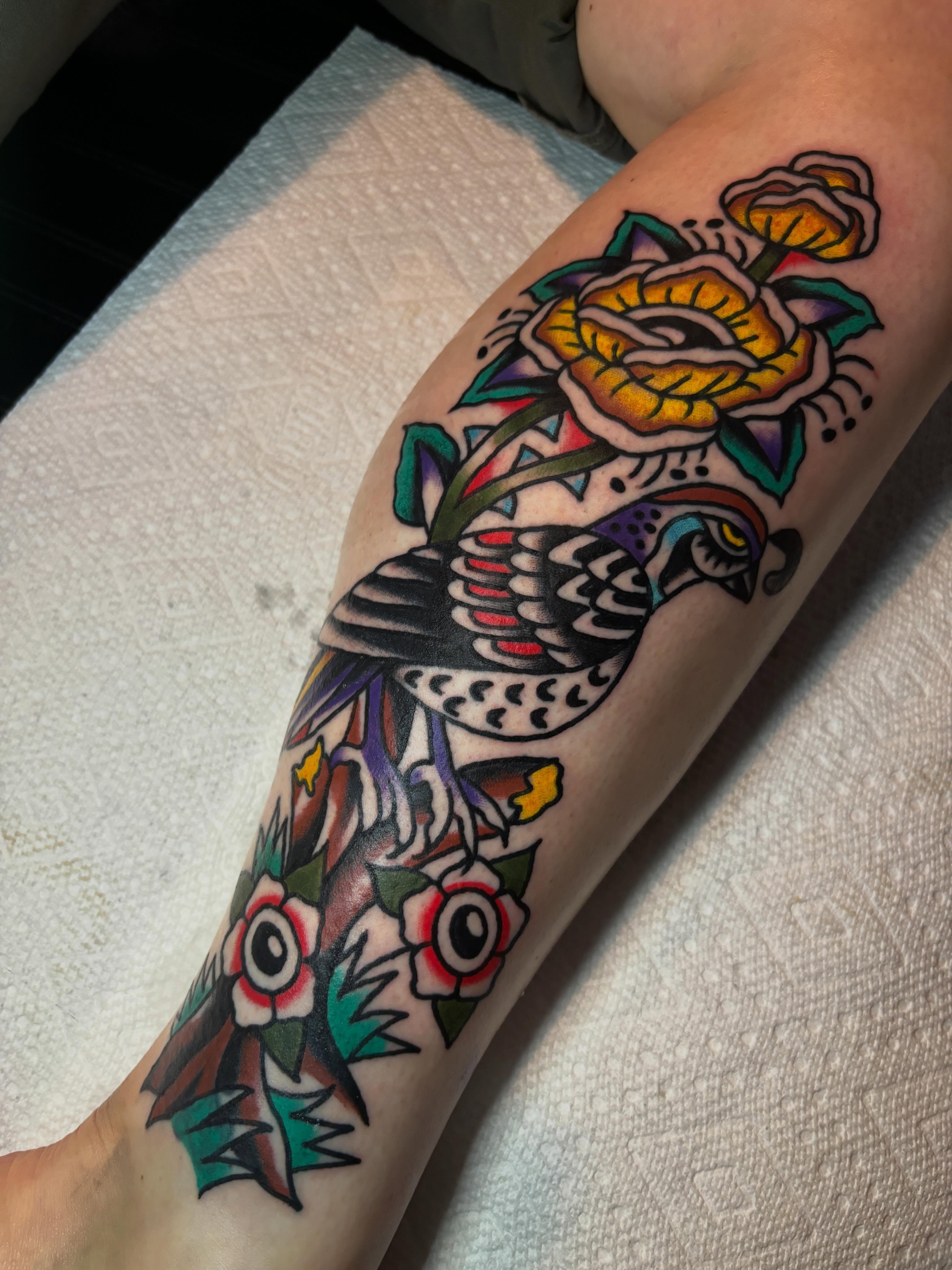Bird and roses American traditional tattoo on the forearm by Mitch Ashpaugh