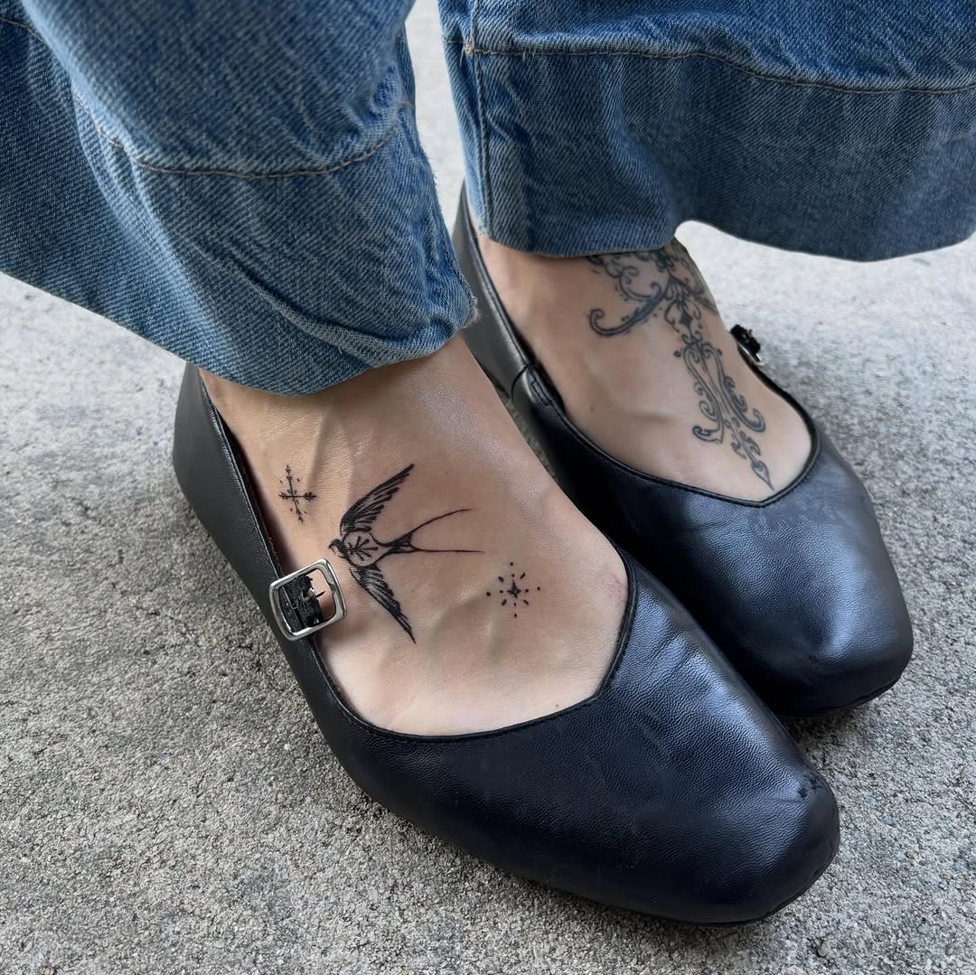 Swallow bird with celestial elements fine line tattoo on the foot by elizaveta