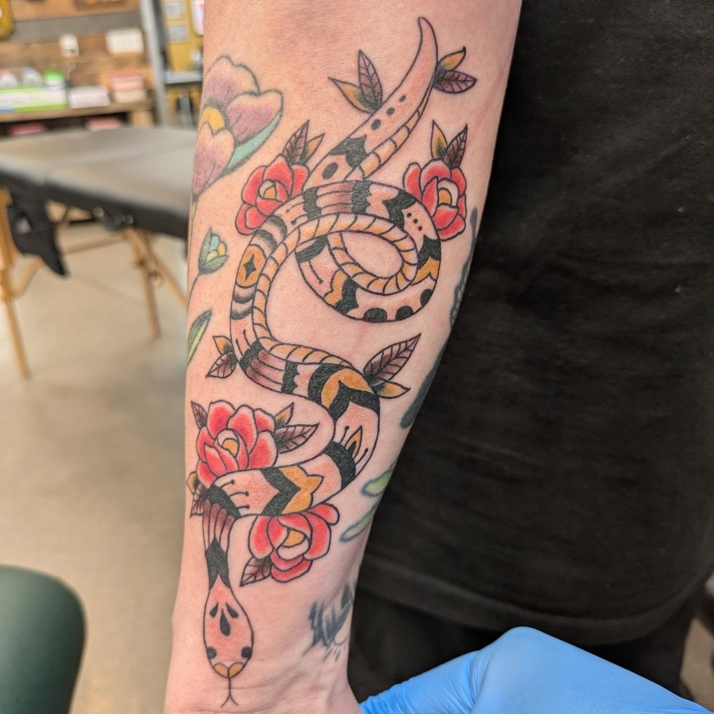 Snake and flowers American traditional tattoo on the forearm by ♡ Cora ♡