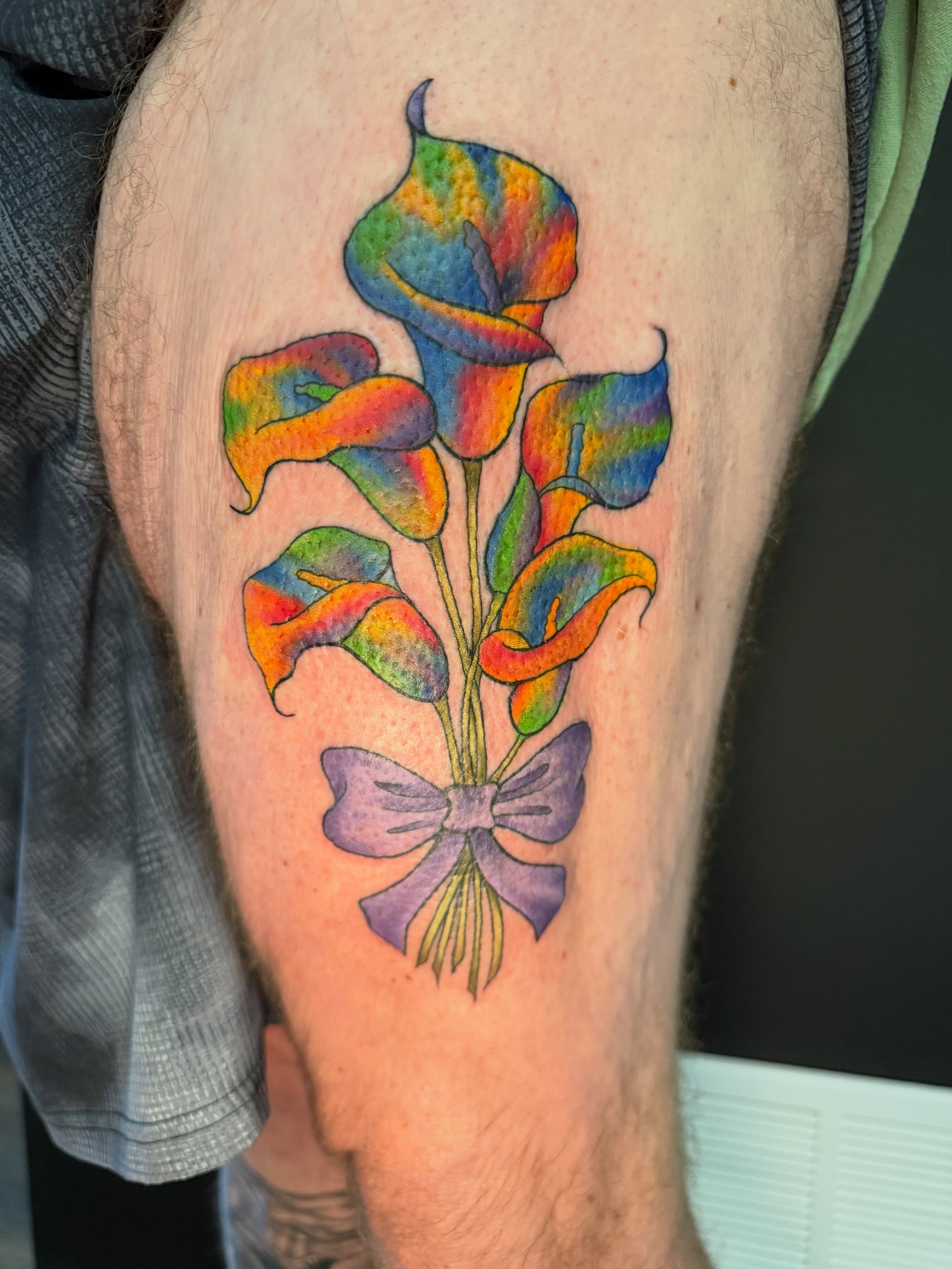 Calla lilies new school tattoo on the thigh by Michelle Balhan
