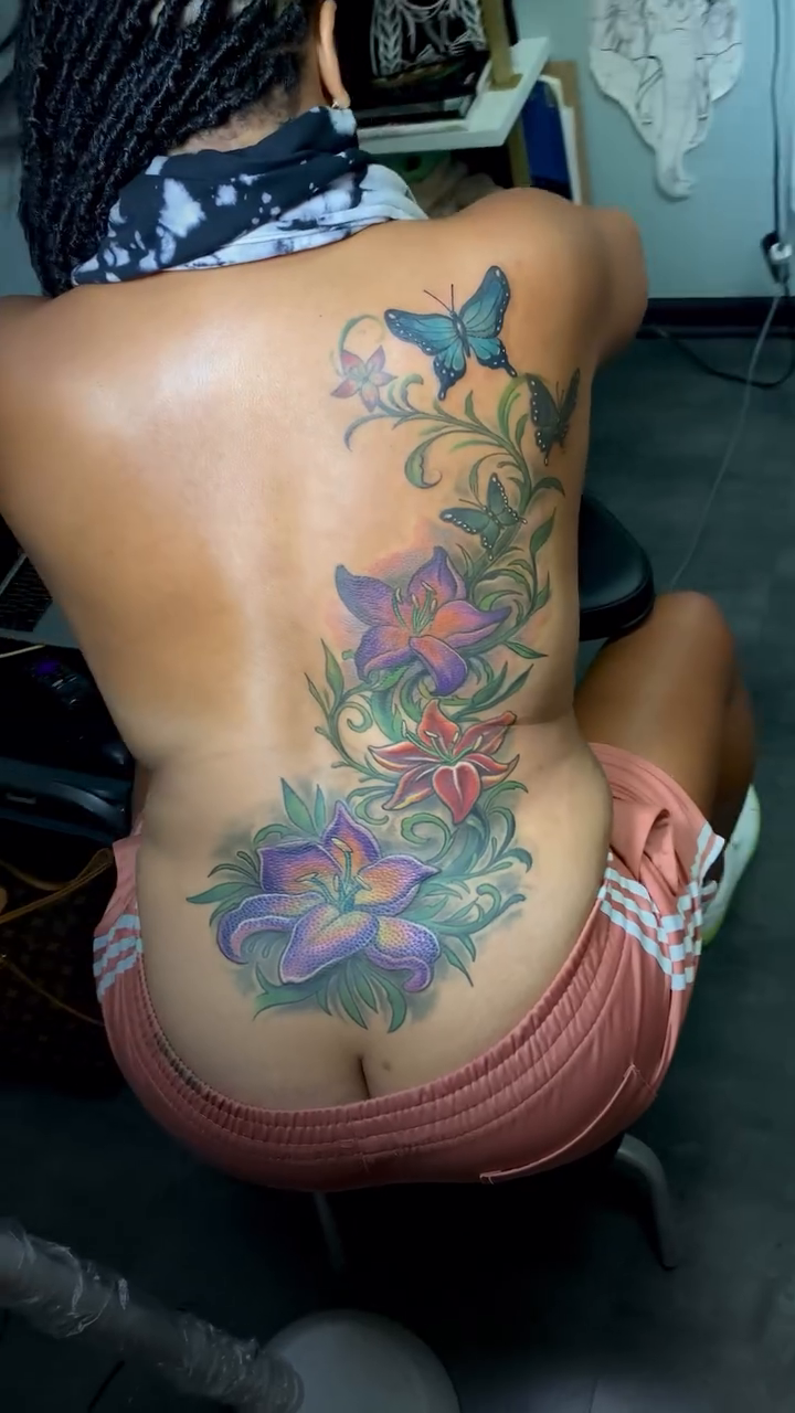 Floral arrangement with butterflies watercolor tattoo on the back by Yulia Chekir, Chicago, Illinois