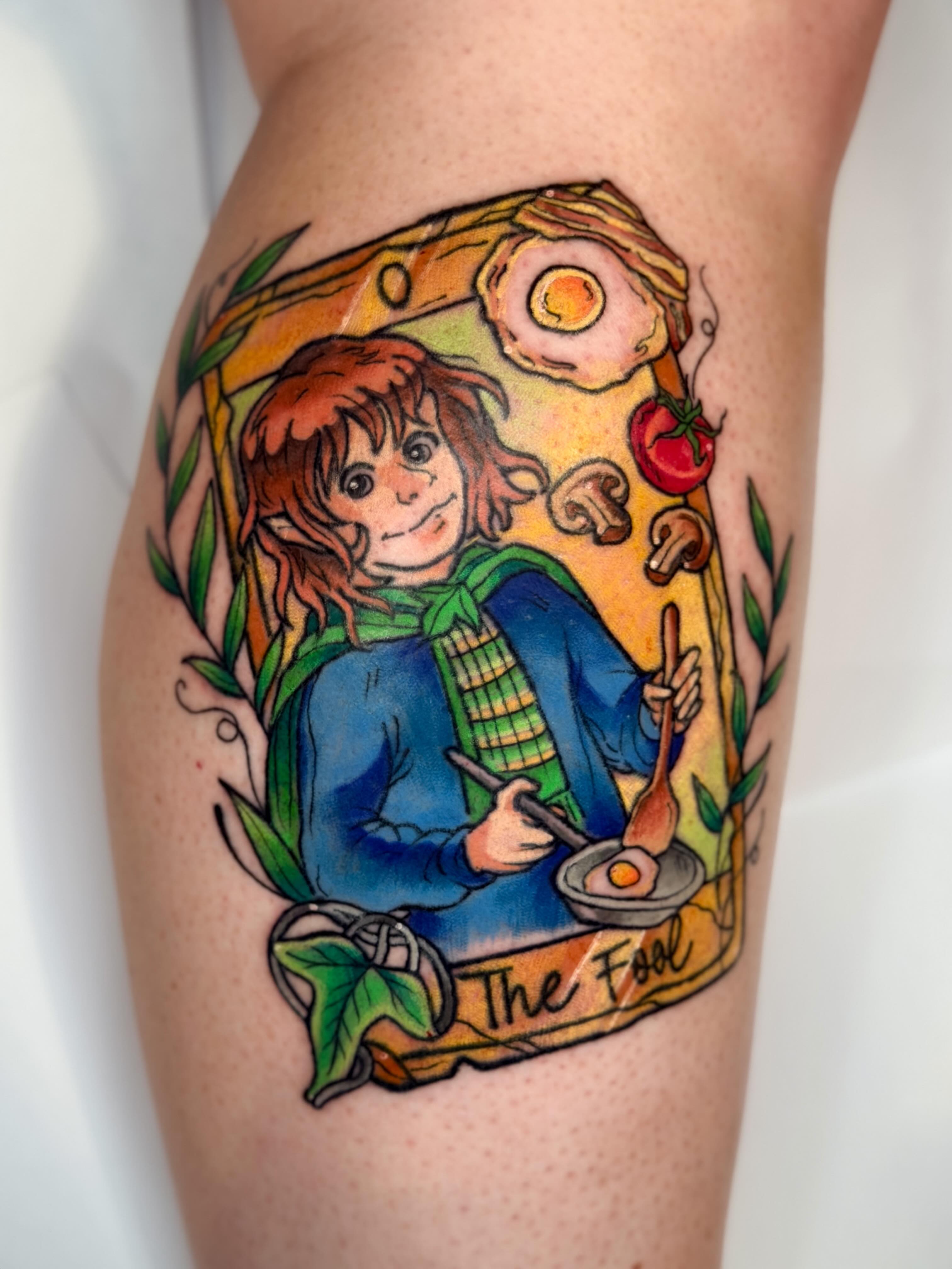 The fool tarot card illustrative tattoo on the thigh by Constance Roberts