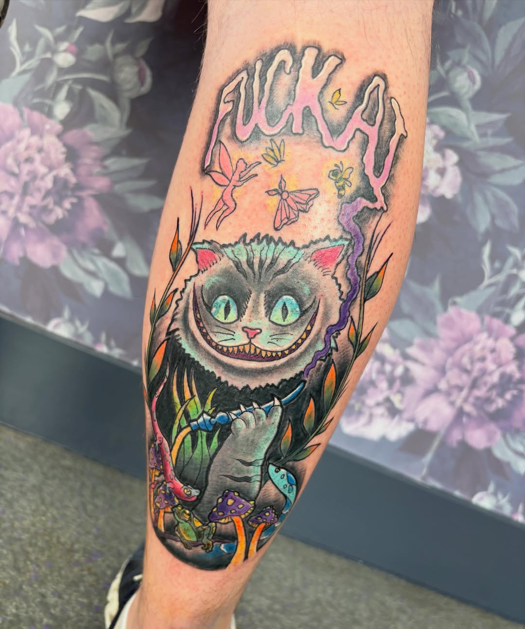 Cheshire cat new school tattoo on the forearm by Bre Alex