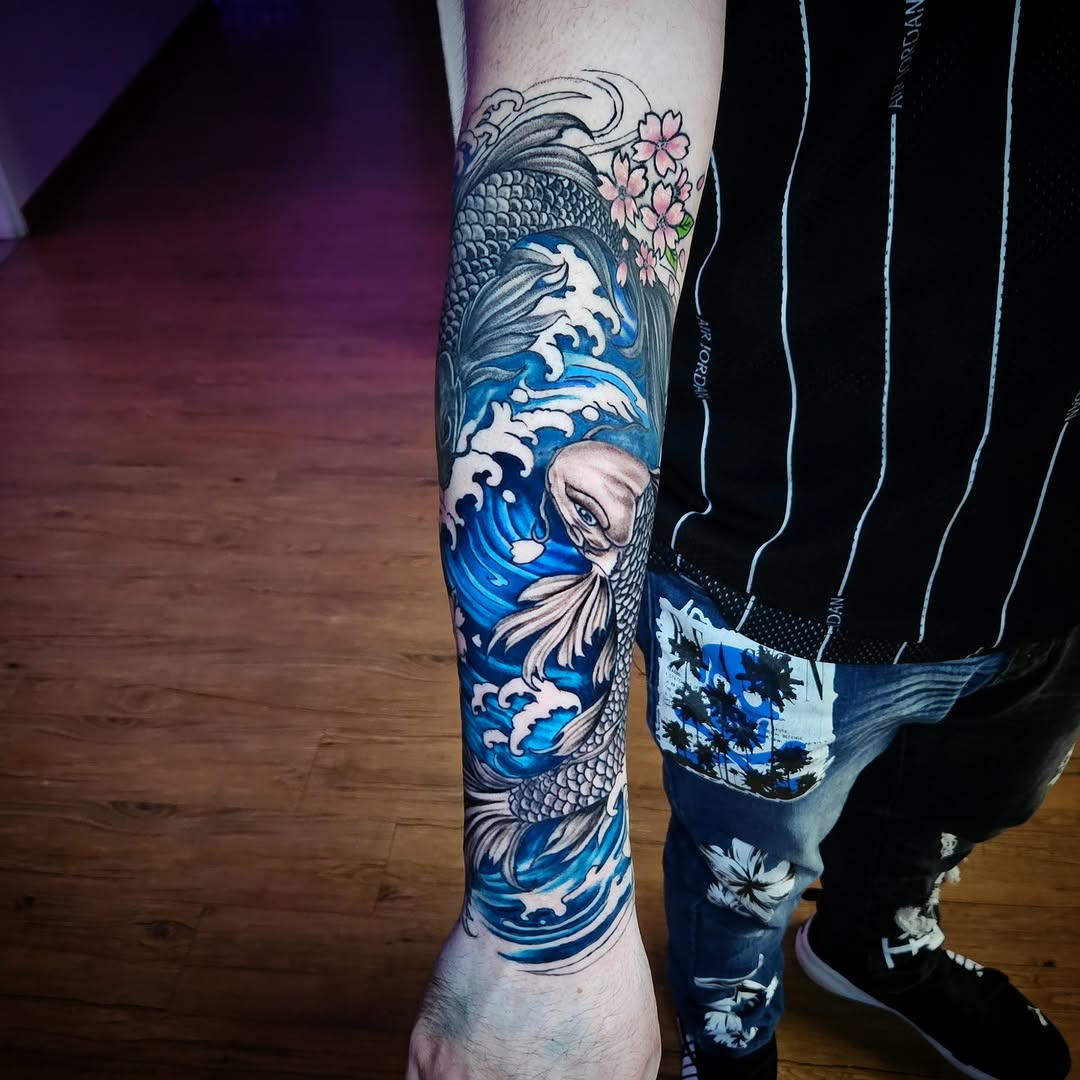 Koi fish and waves japanese irezumi tattoo on the forearm by Isaac Morales