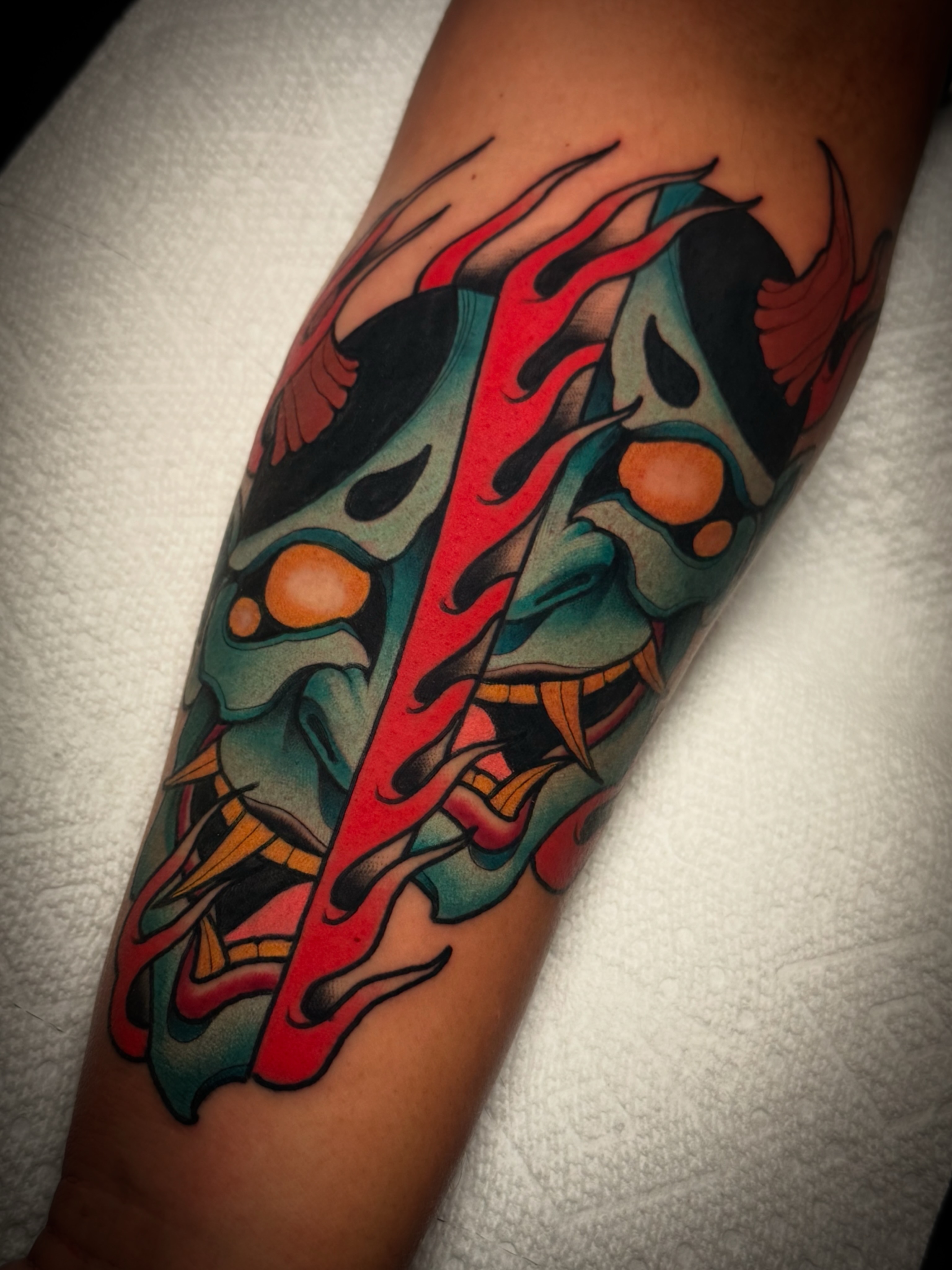Demon mask American traditional tattoo on the forearm by Dave Osrowitz