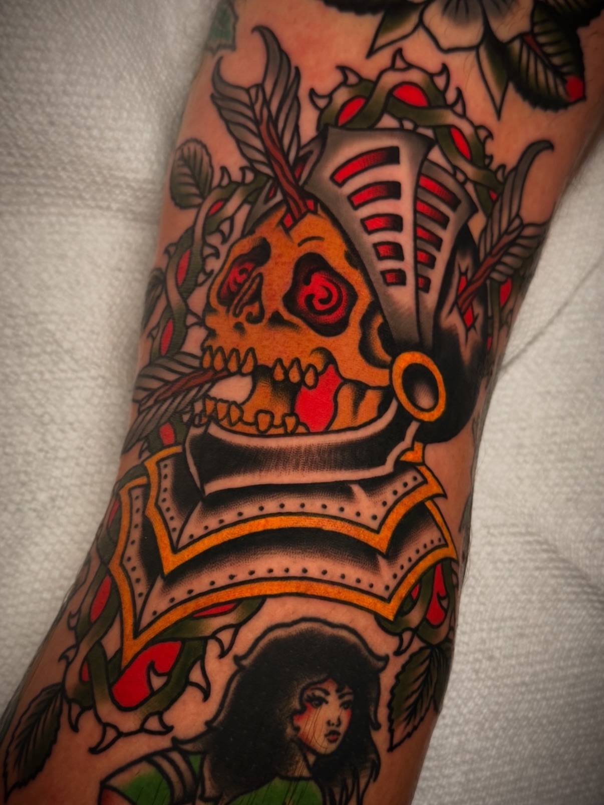 Skull and armor American traditional tattoo on the forearm by Dave Osrowitz
