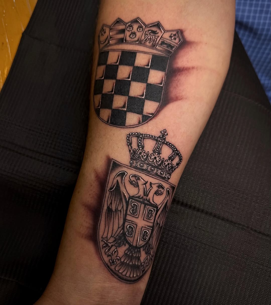 Coat of arms black and grey tattoo on the forearm by Abigail Lewis