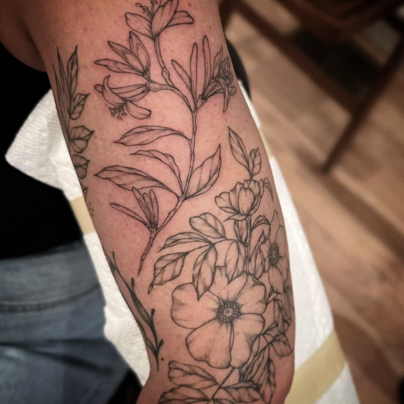 Floral arrangement black and grey tattoo on the forearm by Daniel Anthony, Philadelphia, Pennsylvania