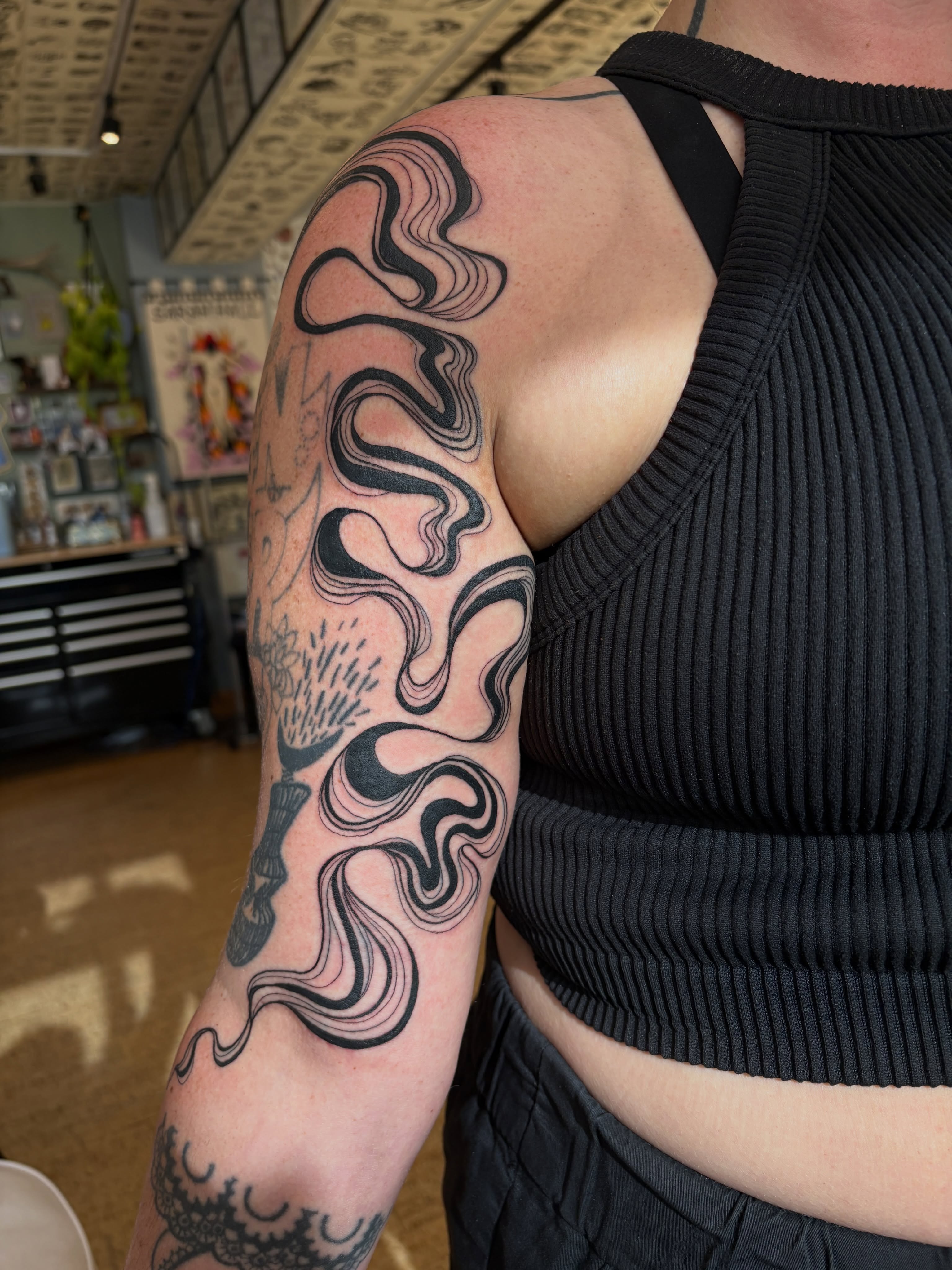 Abstract wave black and grey tattoo on the forearm by Kimber Teatro, Portland, Oregon