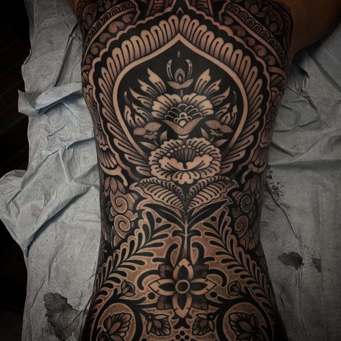 Floral mandala geometric tattoo on the forearm by Pat Moser