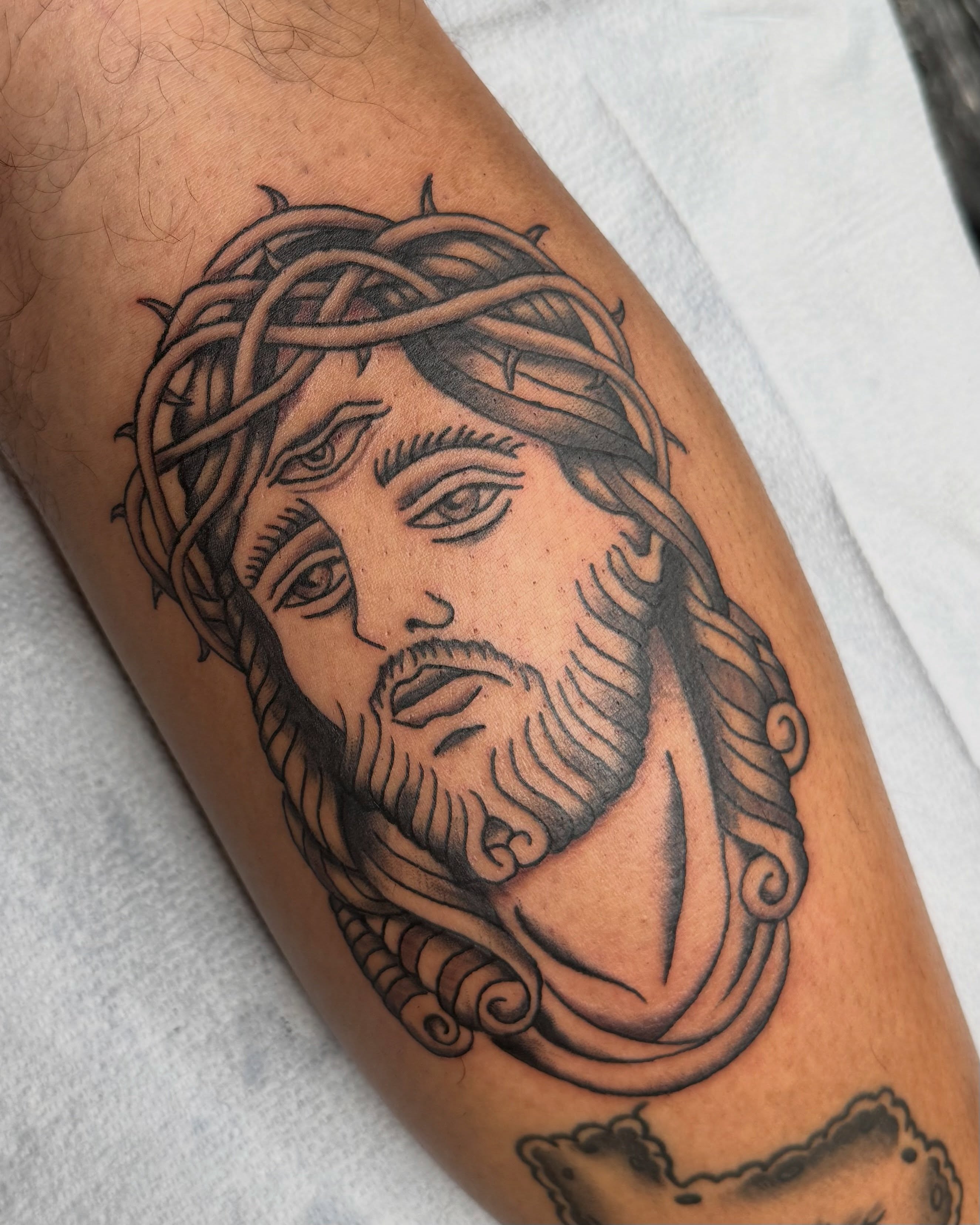 Religious figure black and grey tattoo on the forearm by Tyler H. Moon