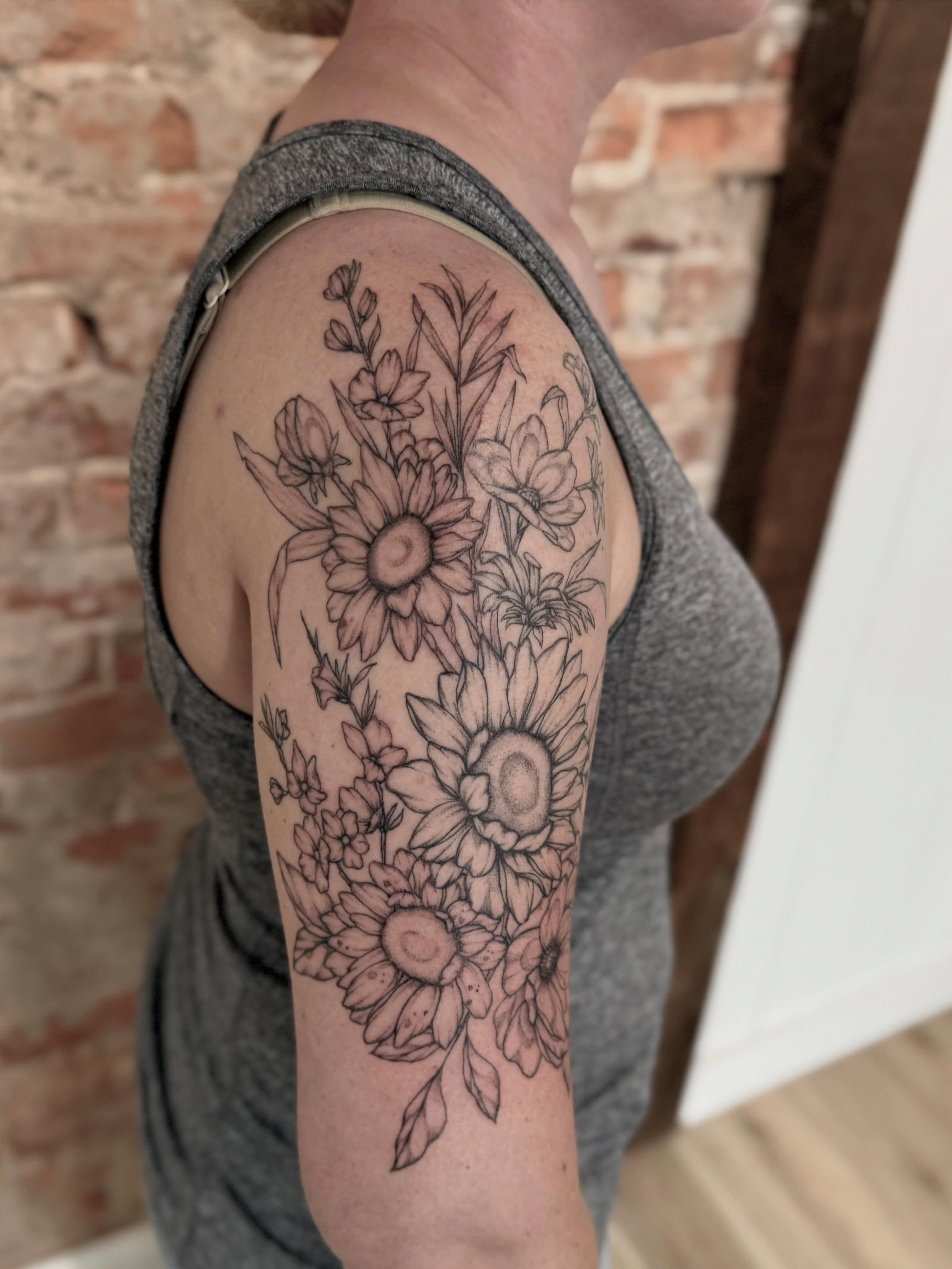 Sunflowers black and grey tattoo on the upper arm by Daniel Anthony, Philadelphia, Pennsylvania