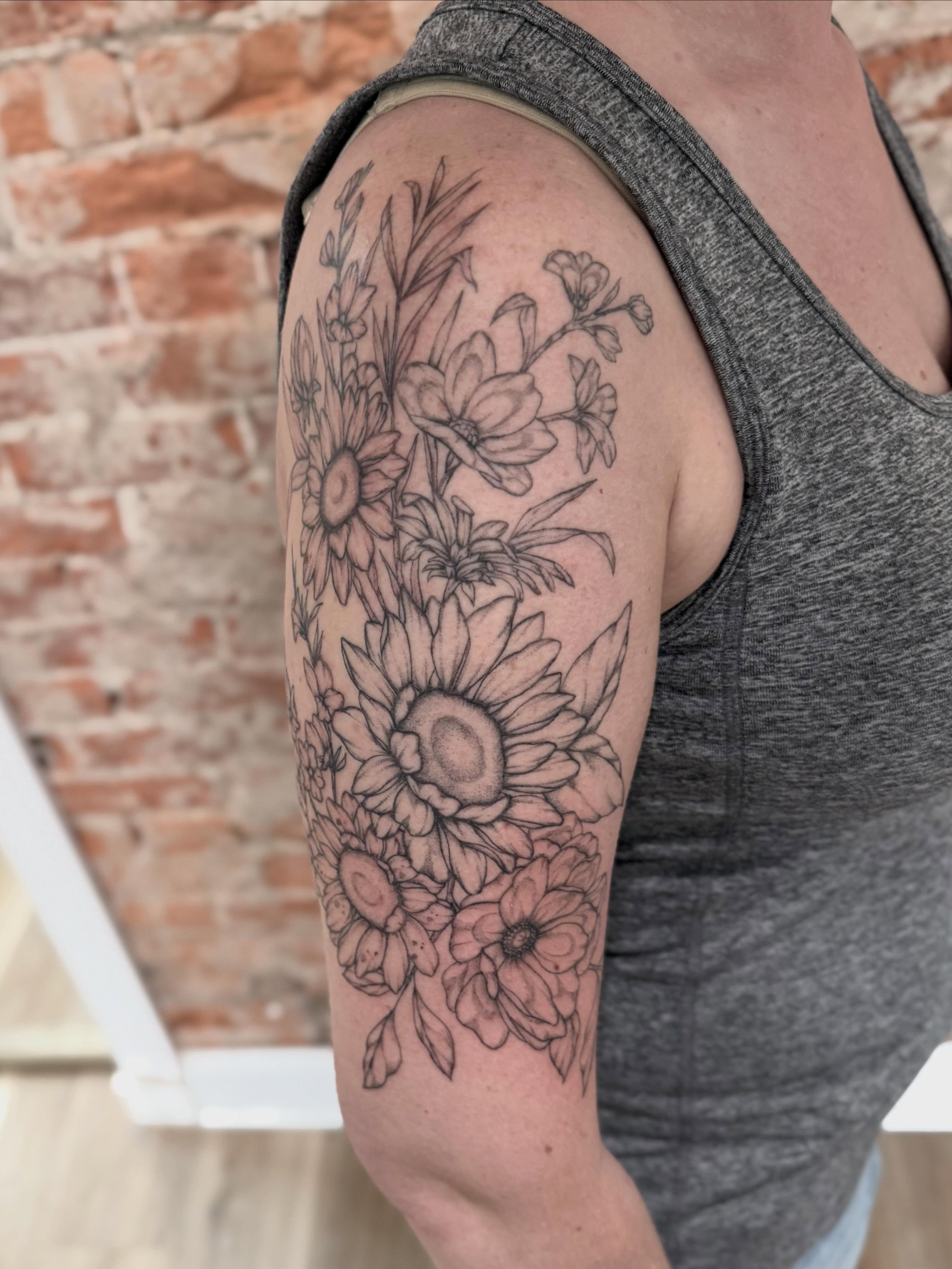 Floral bouquet black and grey tattoo on the upper arm by Daniel Anthony, Philadelphia, Pennsylvania