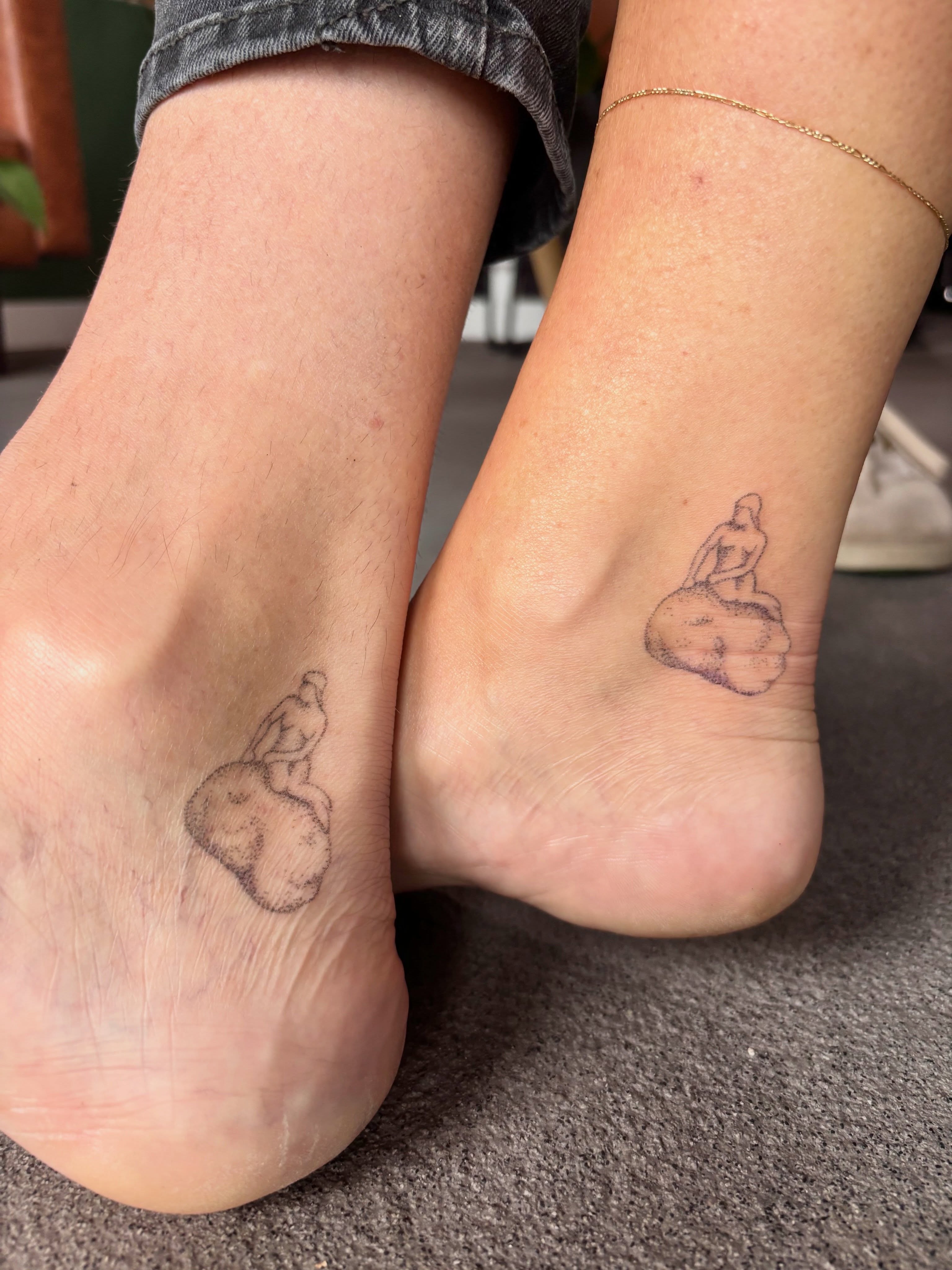 Woman sitting on rock black and grey tattoo on the foot by Ashley, Elk Horn, Iowa