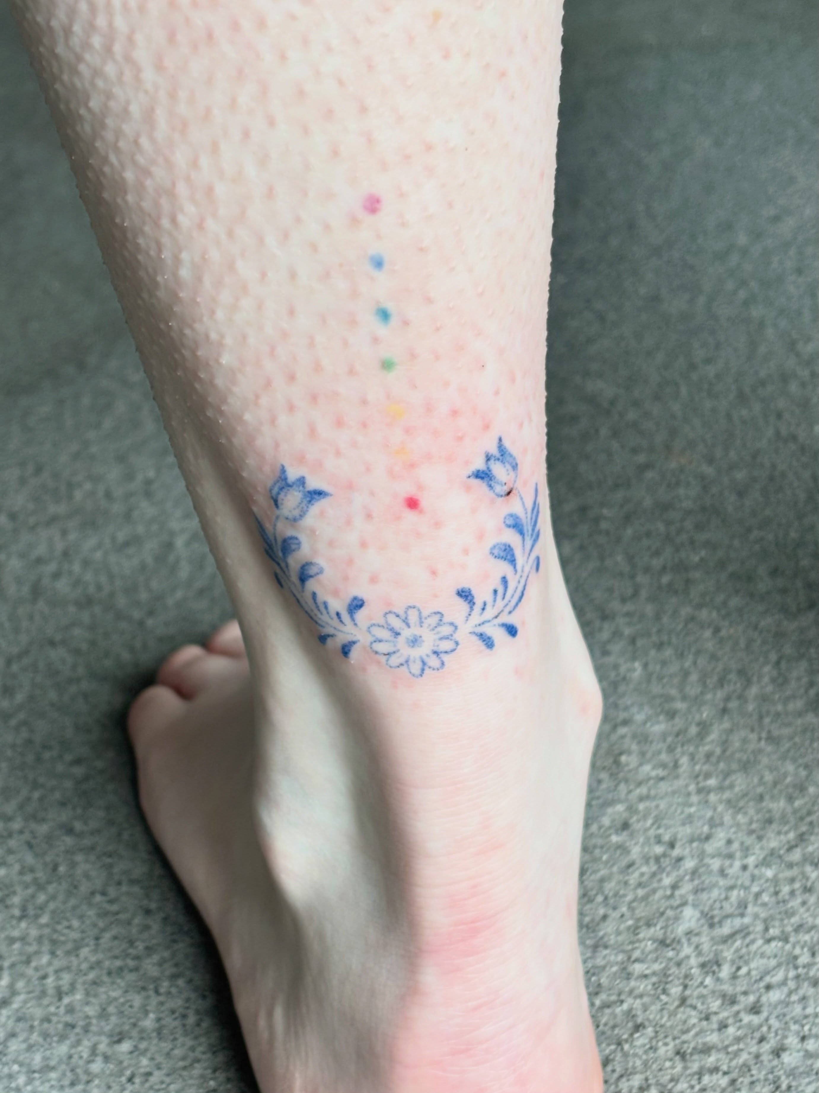 Flower wreath dotwork tattoo on the calf by Ashley, Elk Horn, Iowa