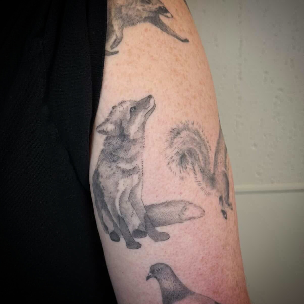 Wolf and squirrel black and grey tattoo on the forearm by Justin Turkus