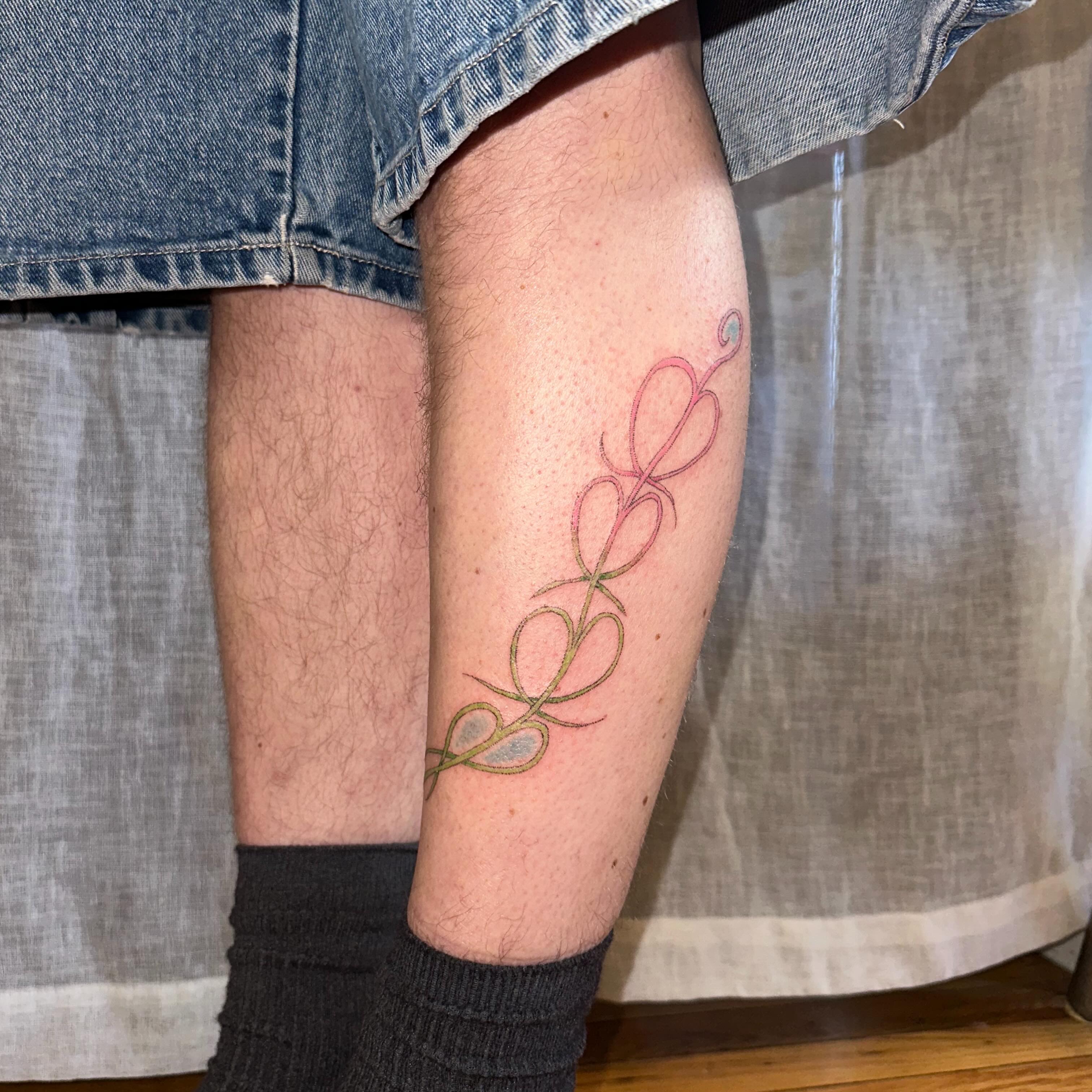Twisted vine fine line tattoo on the calf by kate