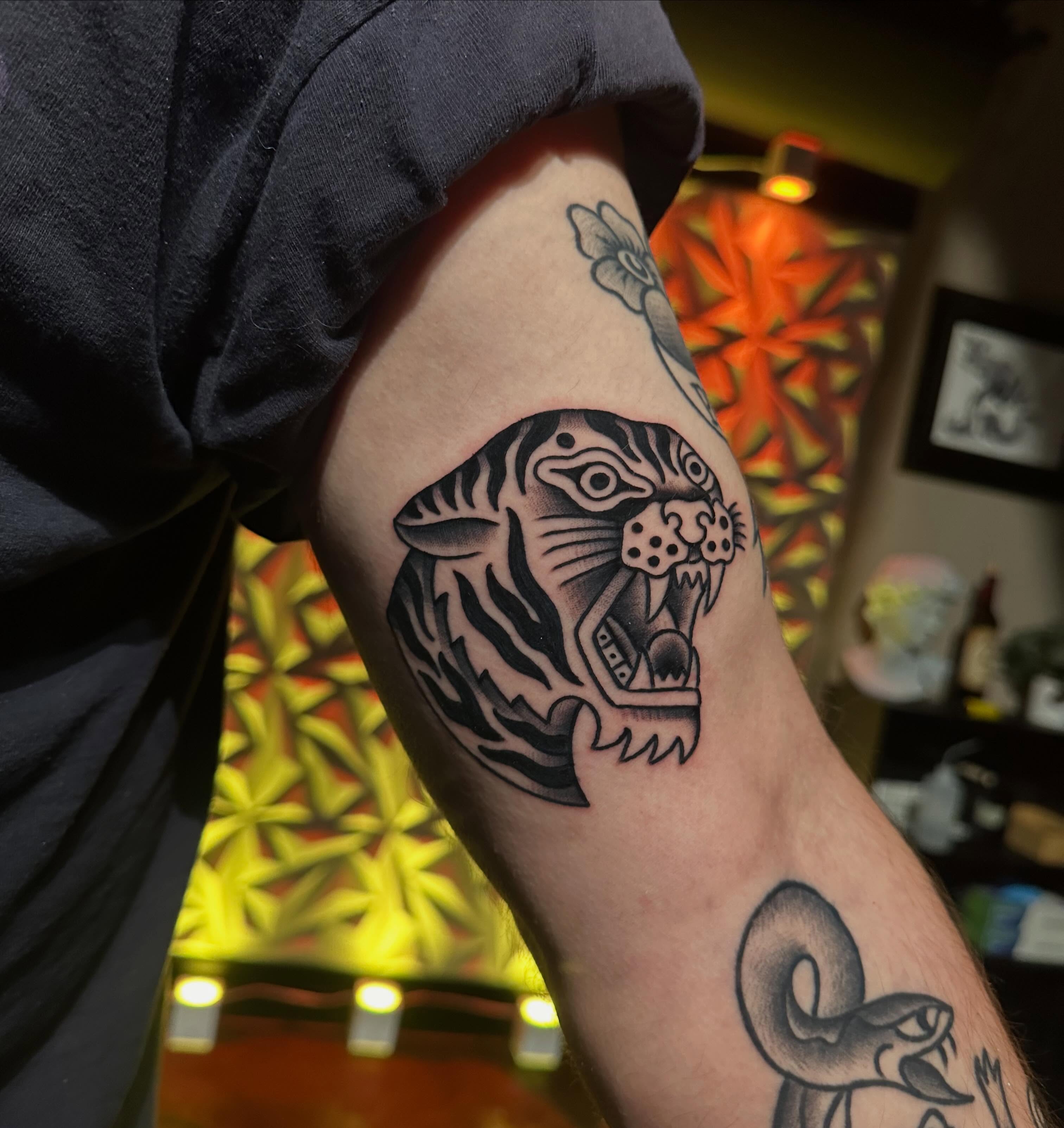 Tiger black and grey tattoo on the forearm by Chi, Charlotte, North Carolina
