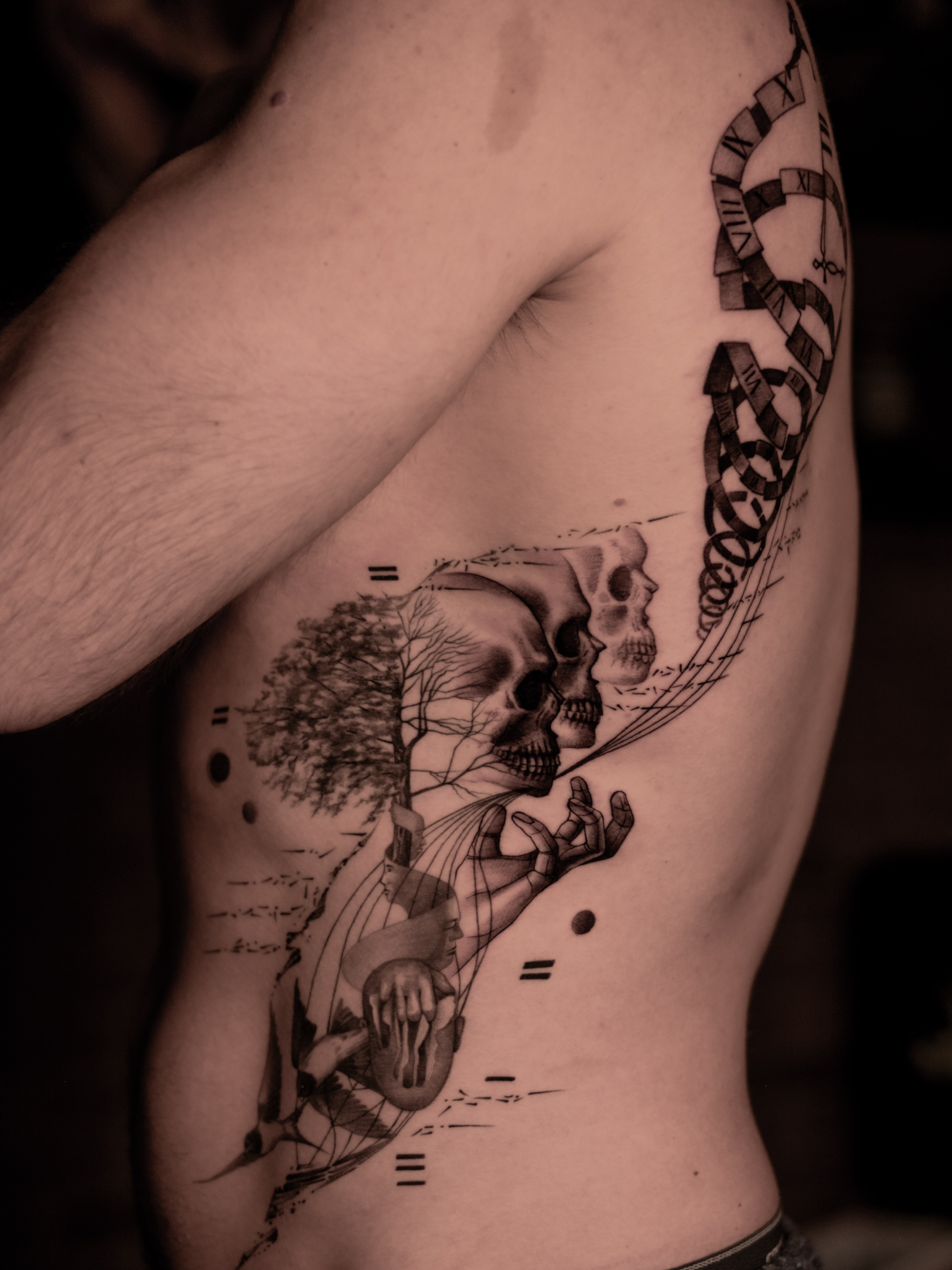 Skulls and tree realism tattoo on the ribs by Mark D, Los Angeles, California