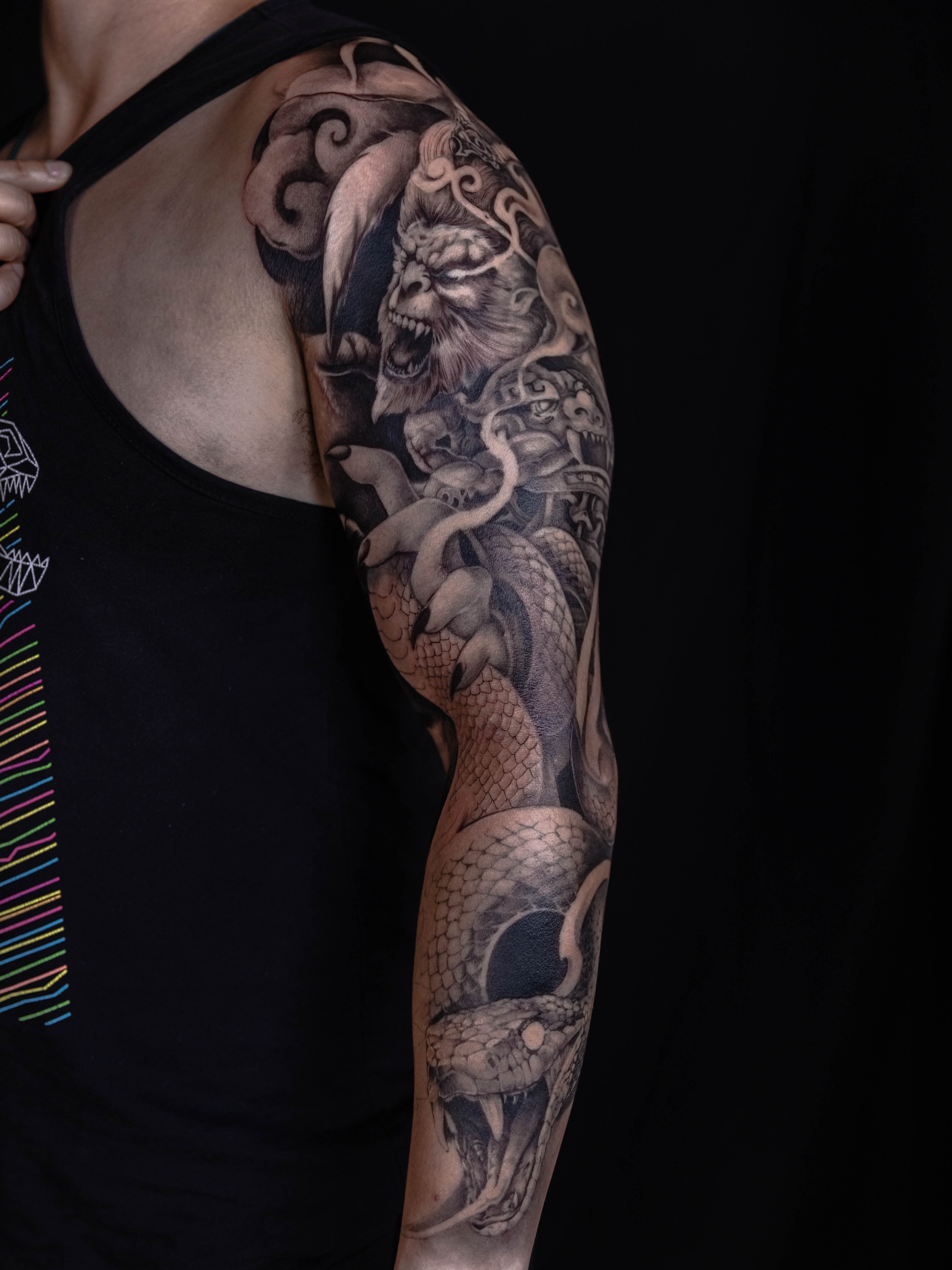 Dragon and demon realism tattoo on the upper arm by LaurenBeez