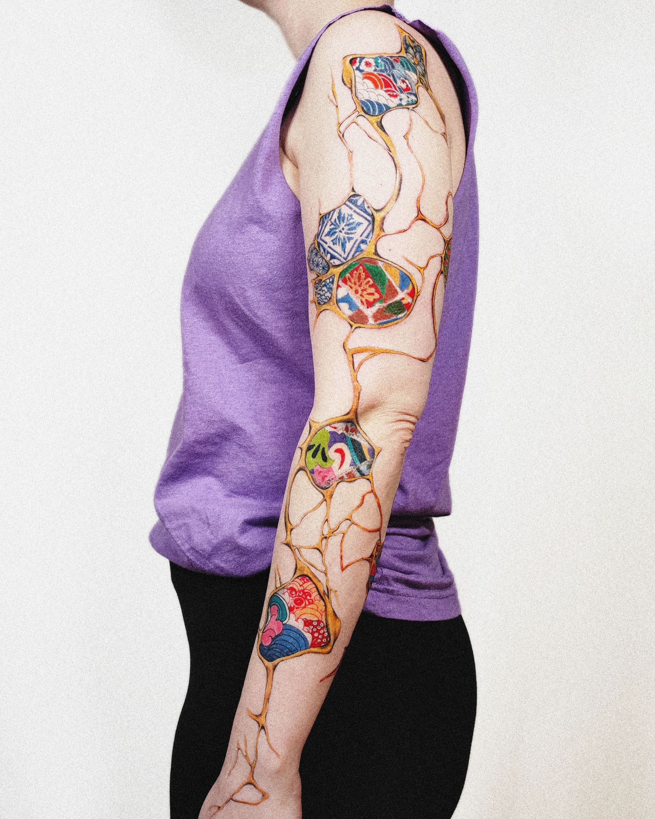 Abstract mosaic watercolor tattoo on the upper arm by 𝗔𝗟𝗘𝗫 𝗣𝗥𝗘𝗤𝗨𝗘𝗟 𝗧𝗔𝗧𝗧𝗢𝗢𝗦 𝗖𝗛𝗜𝗖𝗔𝗚𝗢 ™, Chicago, Illinois