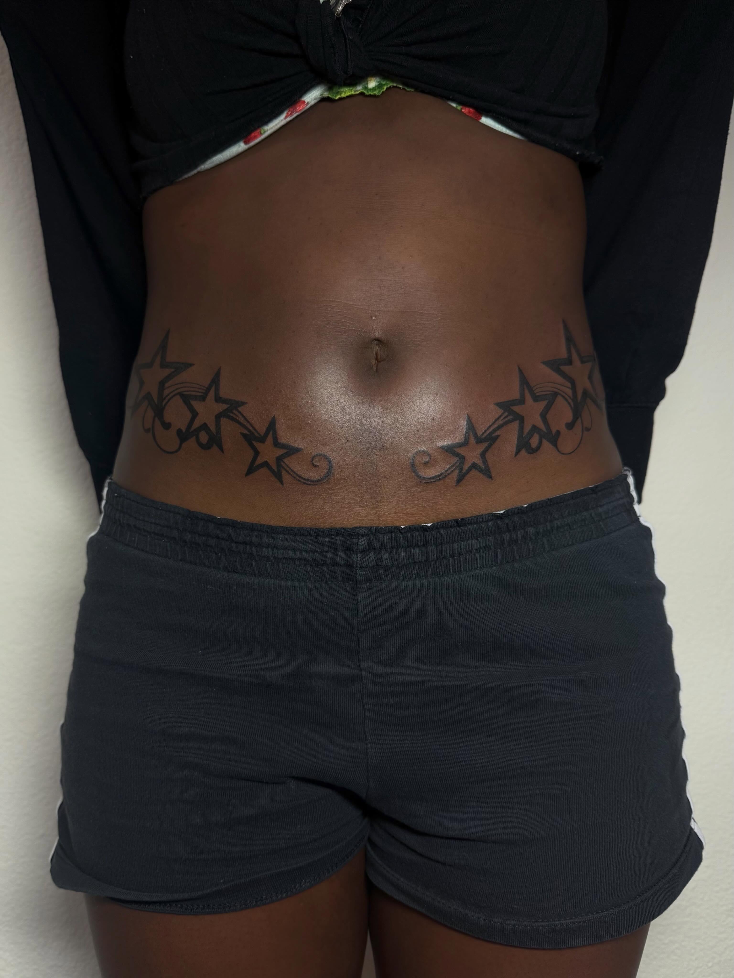 Stars black and grey tattoo on the torso by sarah