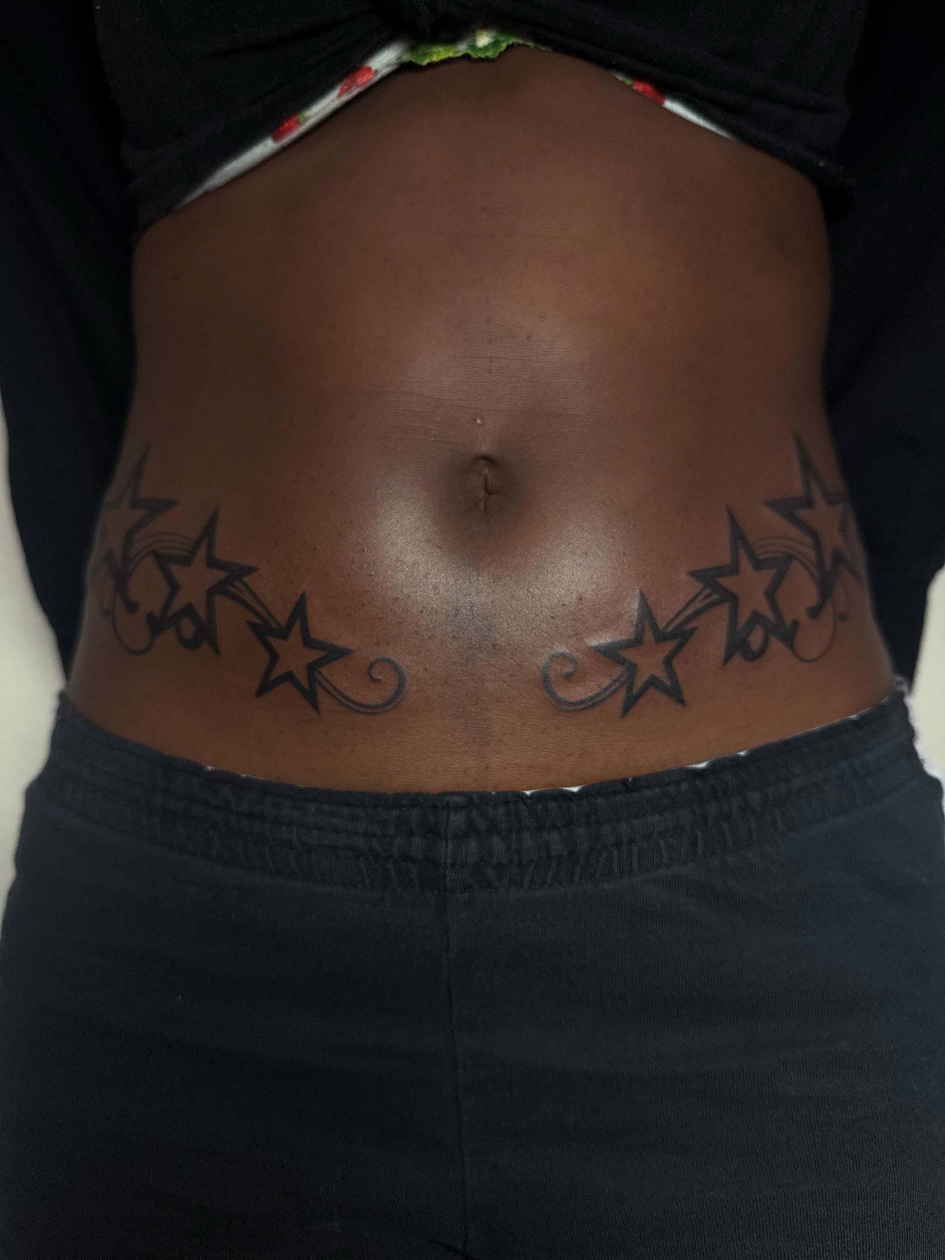 Stars black and grey tattoo on the torso by sarah