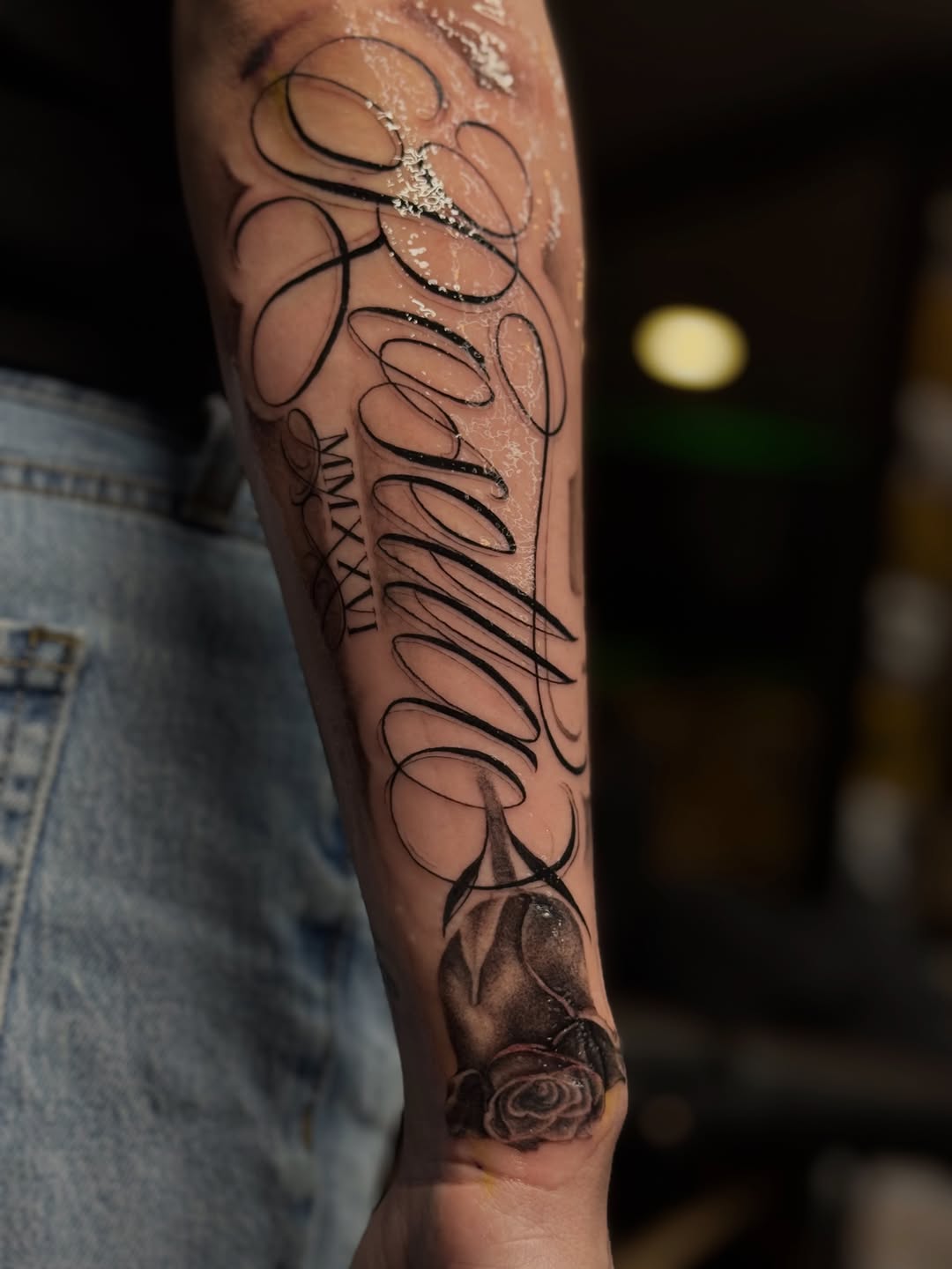 Script lettering and rose lettering tattoo on the forearm by @_frankyvee