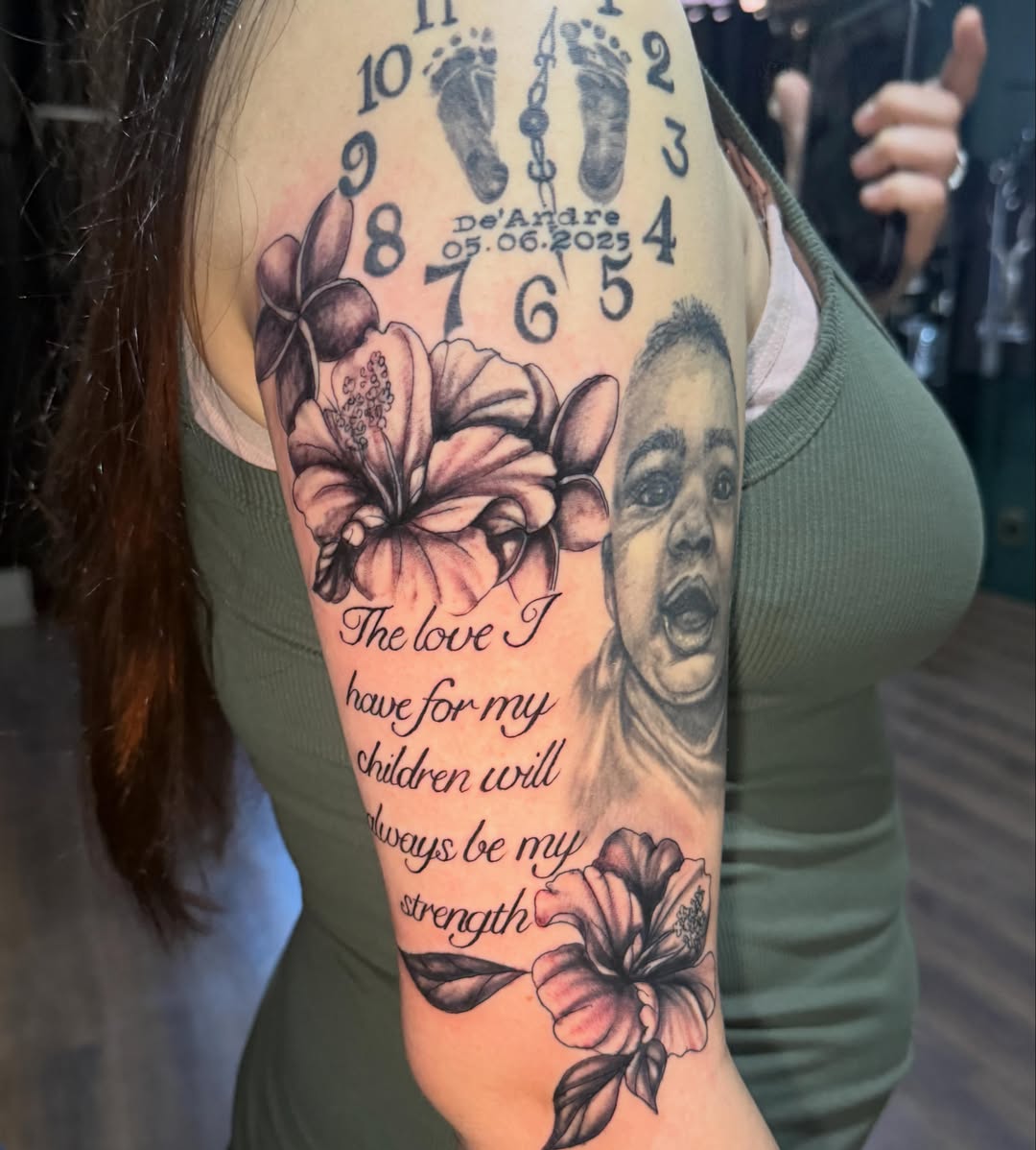 Baby portrait with floral elements realism tattoo on the forearm by Teara faith krigbaum
