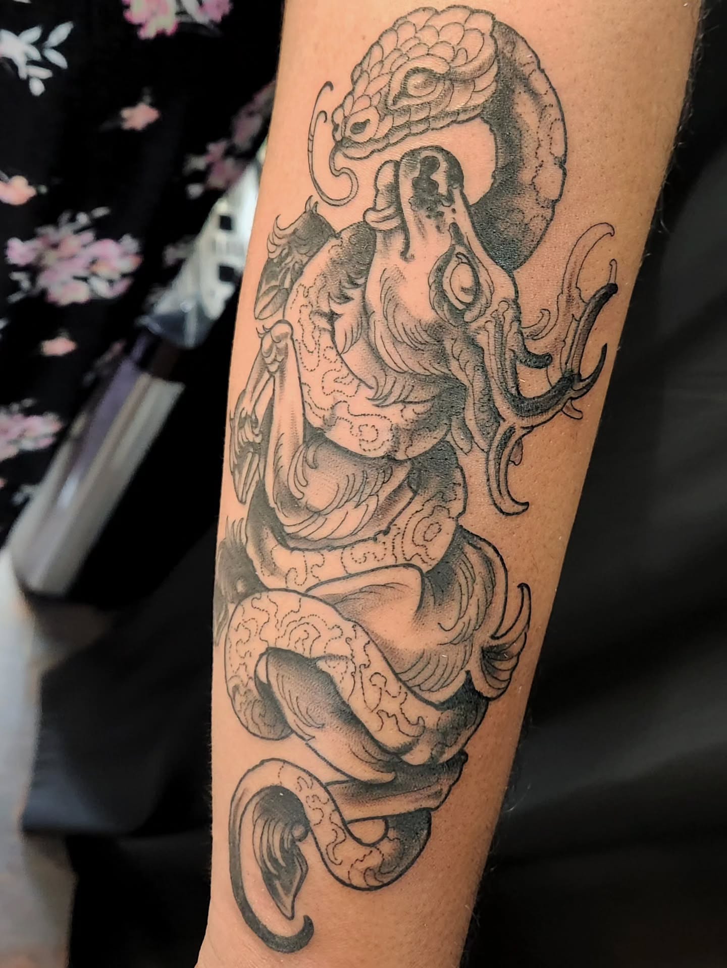 Snake and dragon black and grey tattoo on the forearm by Randy