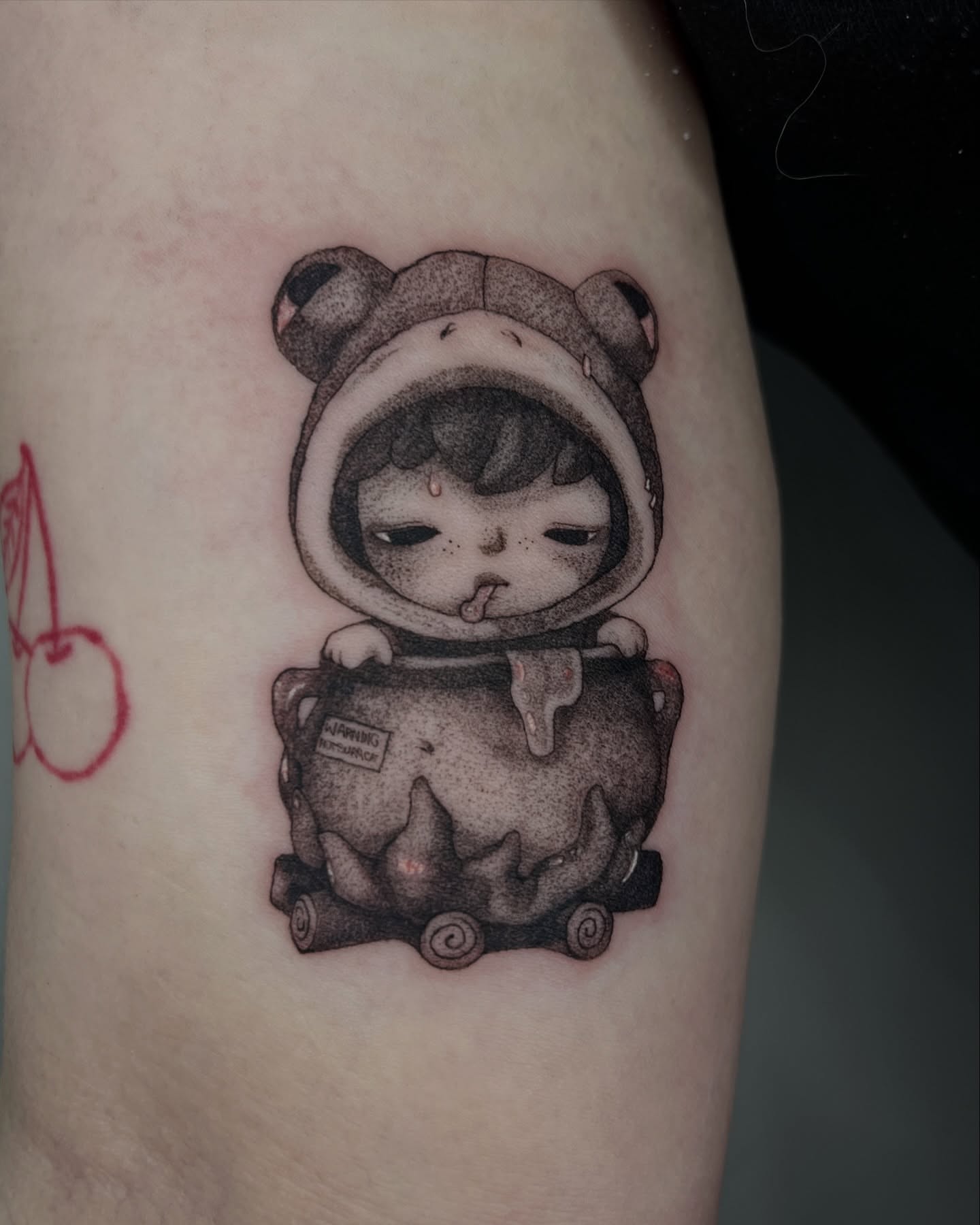 Kawaii character in frog costume dotwork tattoo on the forearm by Sarah Jurgielewicz