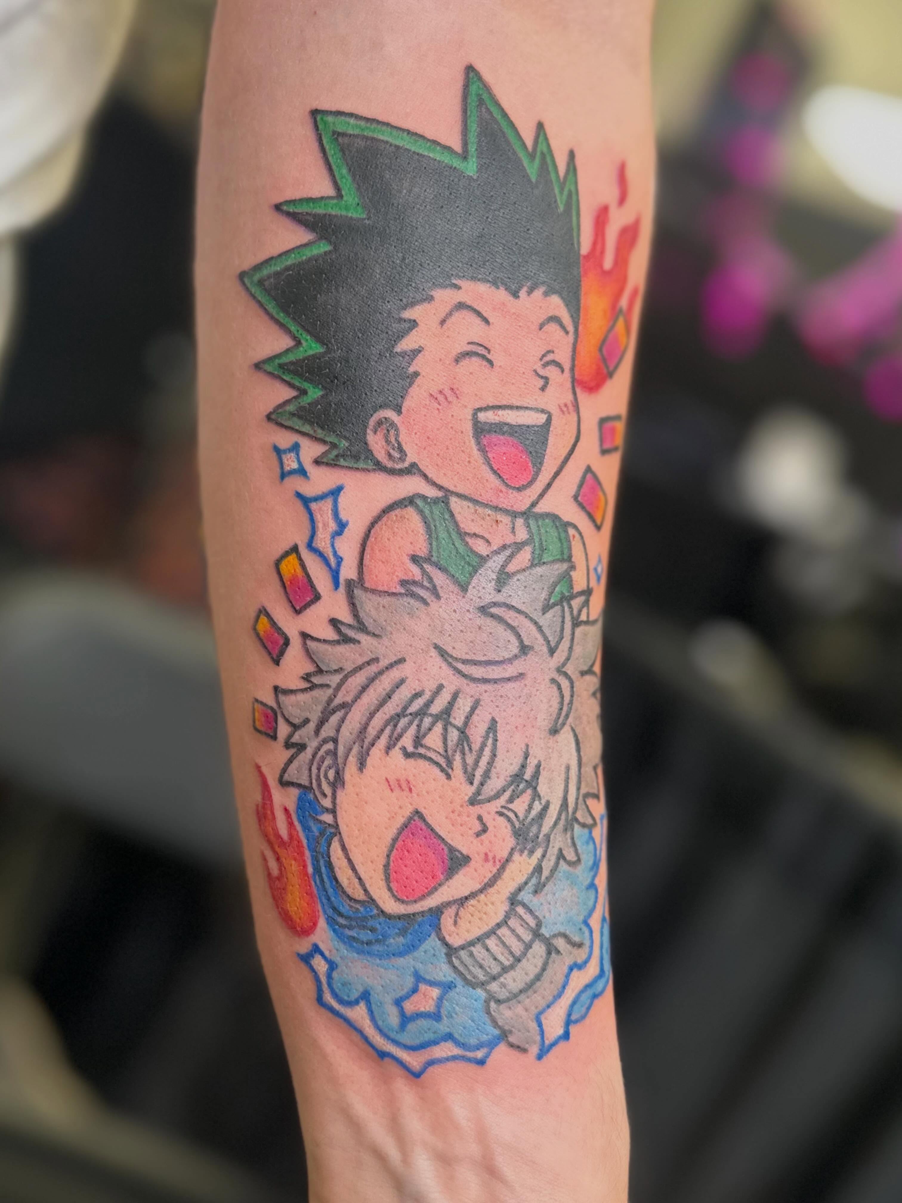 Anime characters anime tattoo on the forearm by Zen Forbes
