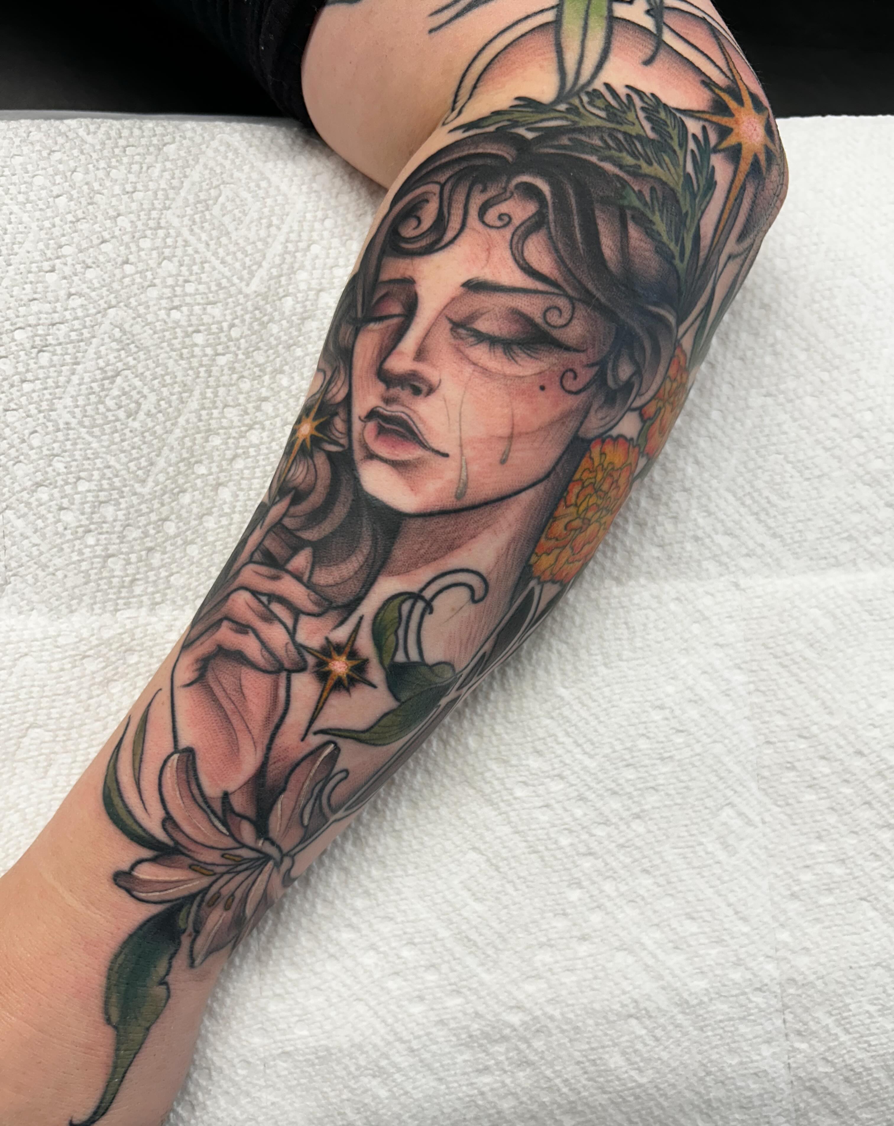 Woman with flowers realism tattoo on the forearm by Kayla Fay, Baton Rouge, Louisiana