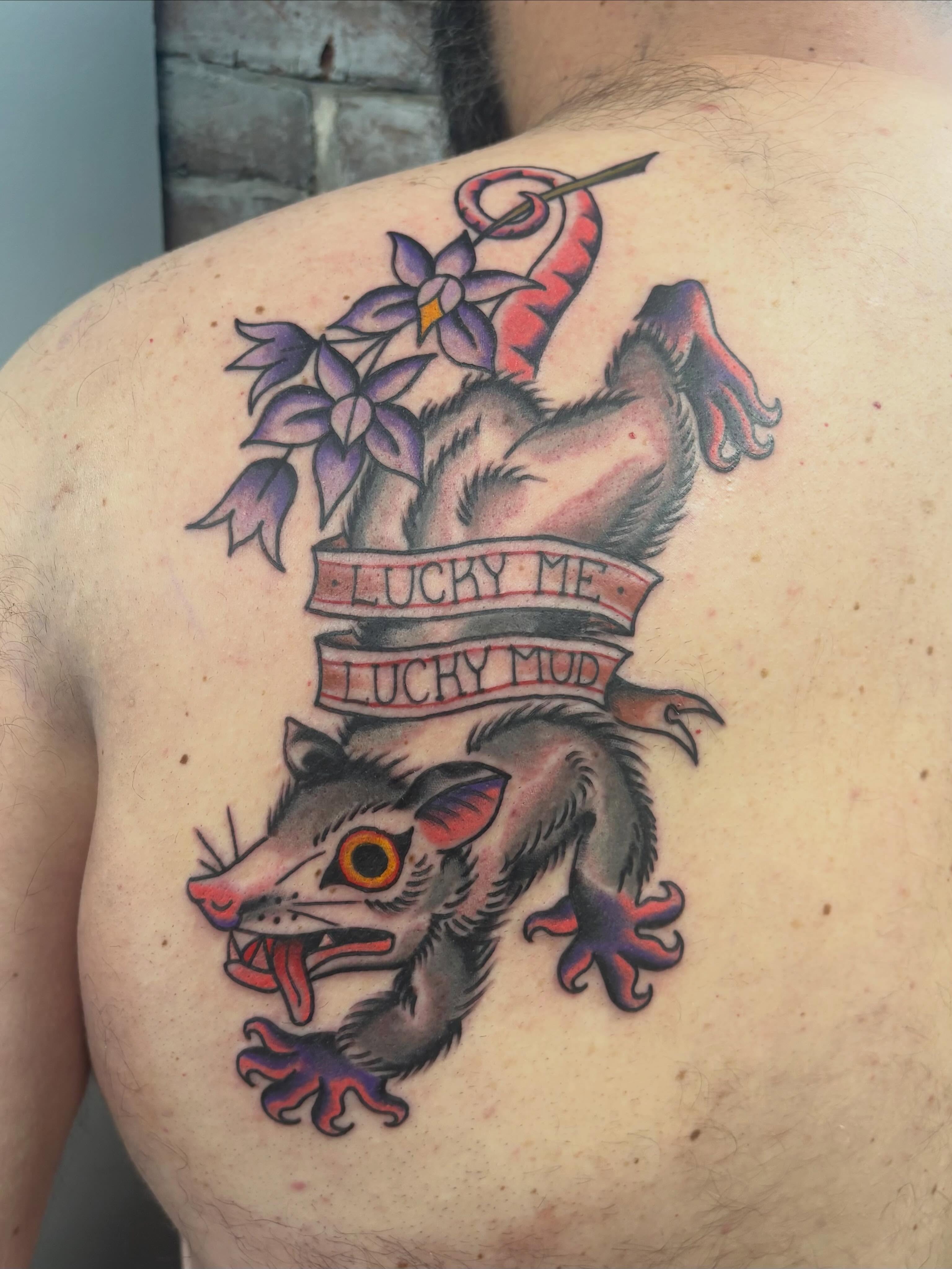 Possum and flowers American traditional tattoo on the shoulder by Nolan Croteau