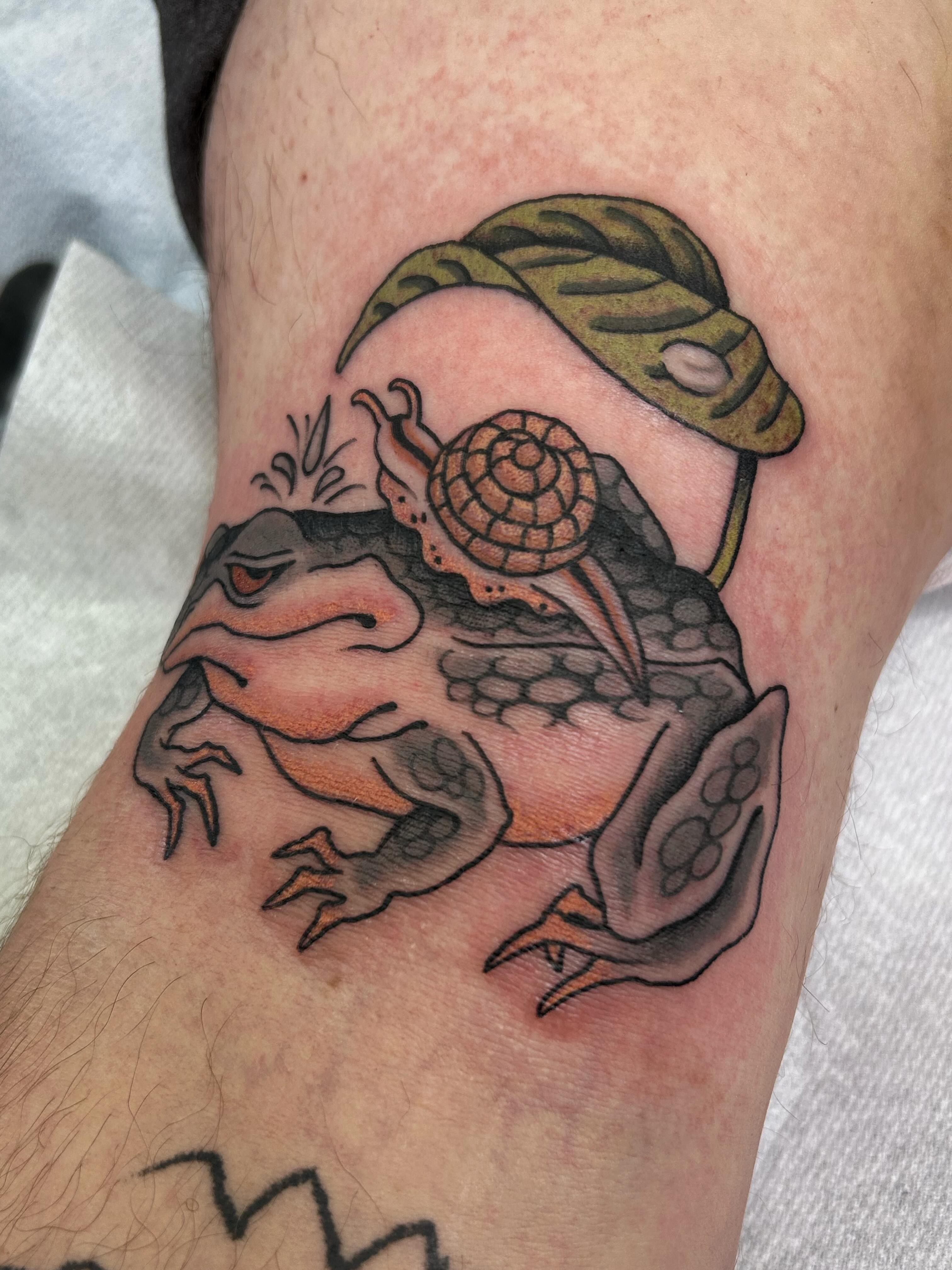 Frog and snail realism tattoo on the forearm by Jade McKenzie, Temecula, California