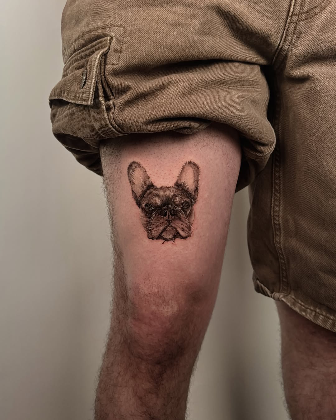 French bulldog realism tattoo on the thigh by Laura Gomez Tattoos