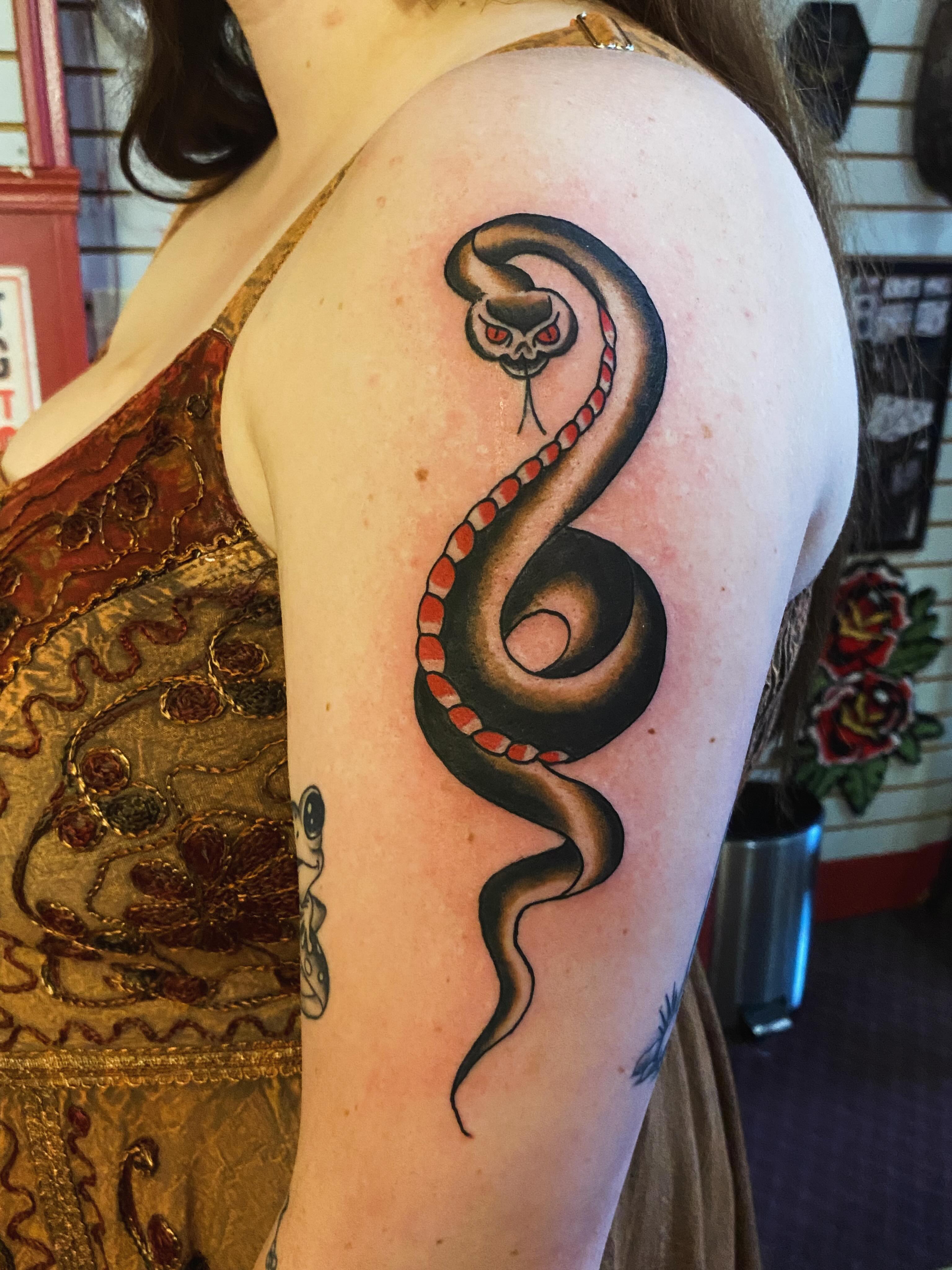 Snake American traditional tattoo on the shoulder by Tommy O'Connell