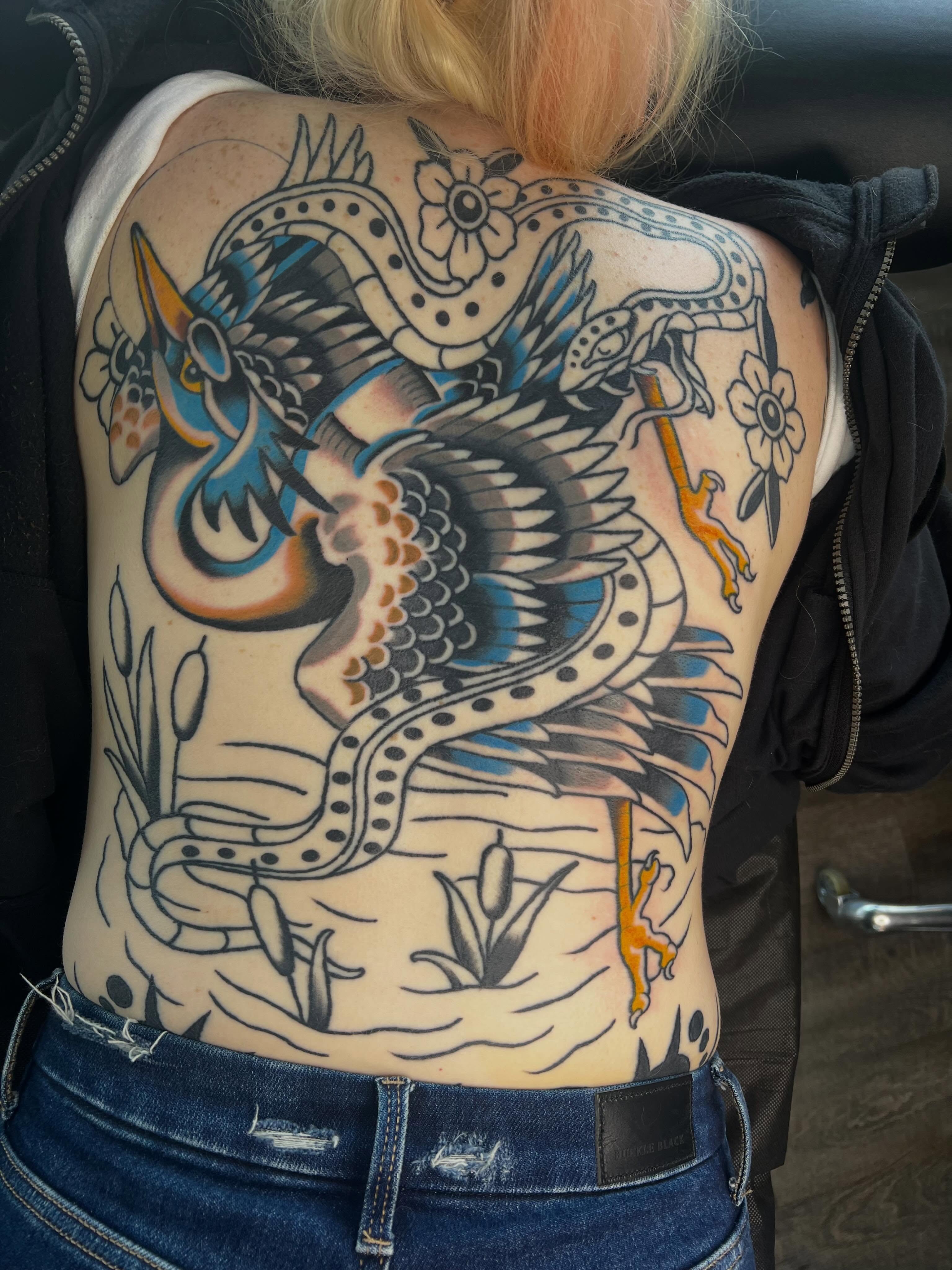 Serpent and flowers American traditional tattoo on the back by Brandon McDaniel Iowa Tattoo Artist