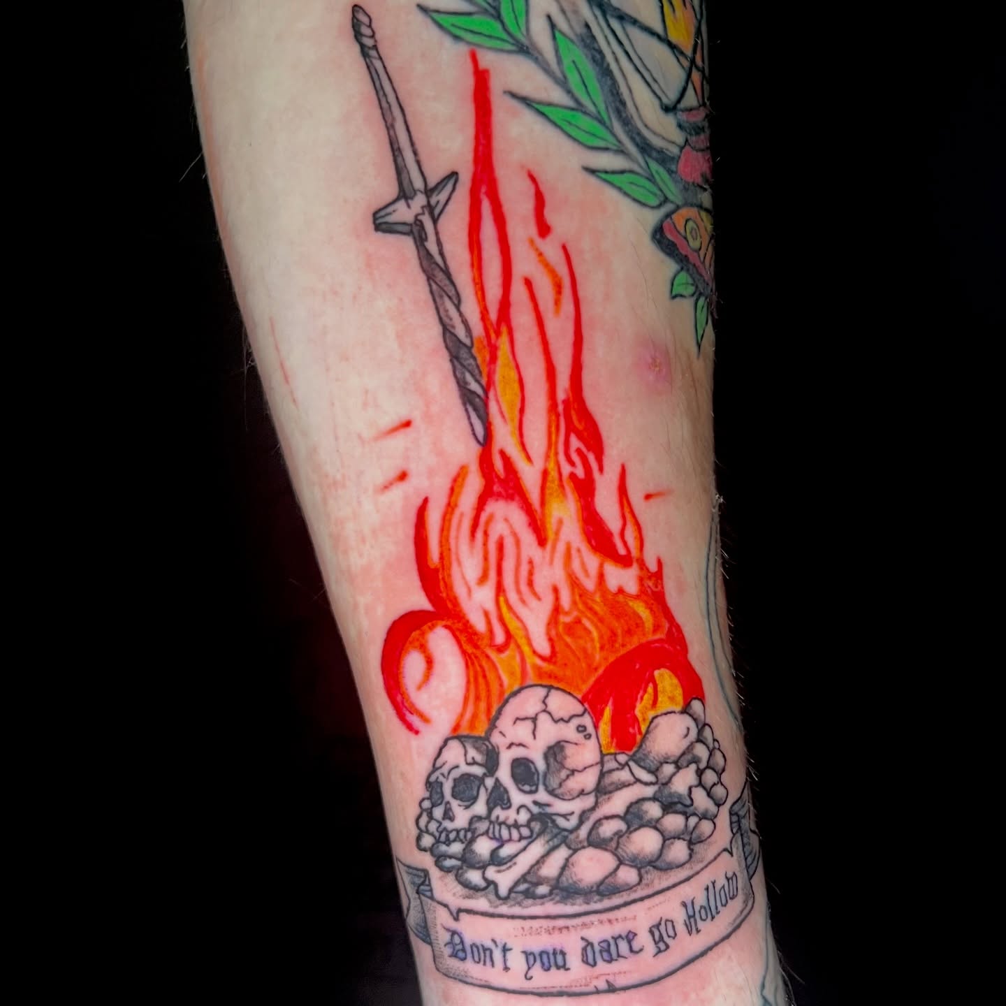 Fire, skulls, sword neo-traditional tattoo on the forearm by Evan Intveld