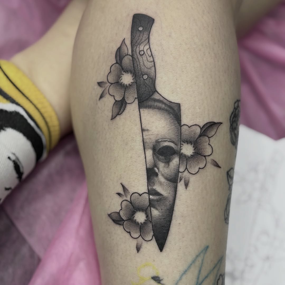 Knife and face realism tattoo on the thigh by Elise Lamoureux- Tattoo Artist, Airdrie, Alberta