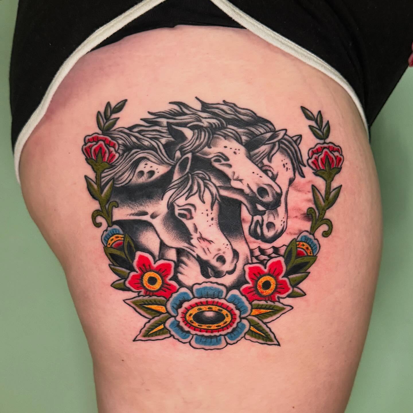 Horses and flowers American traditional tattoo on the thigh by charlie