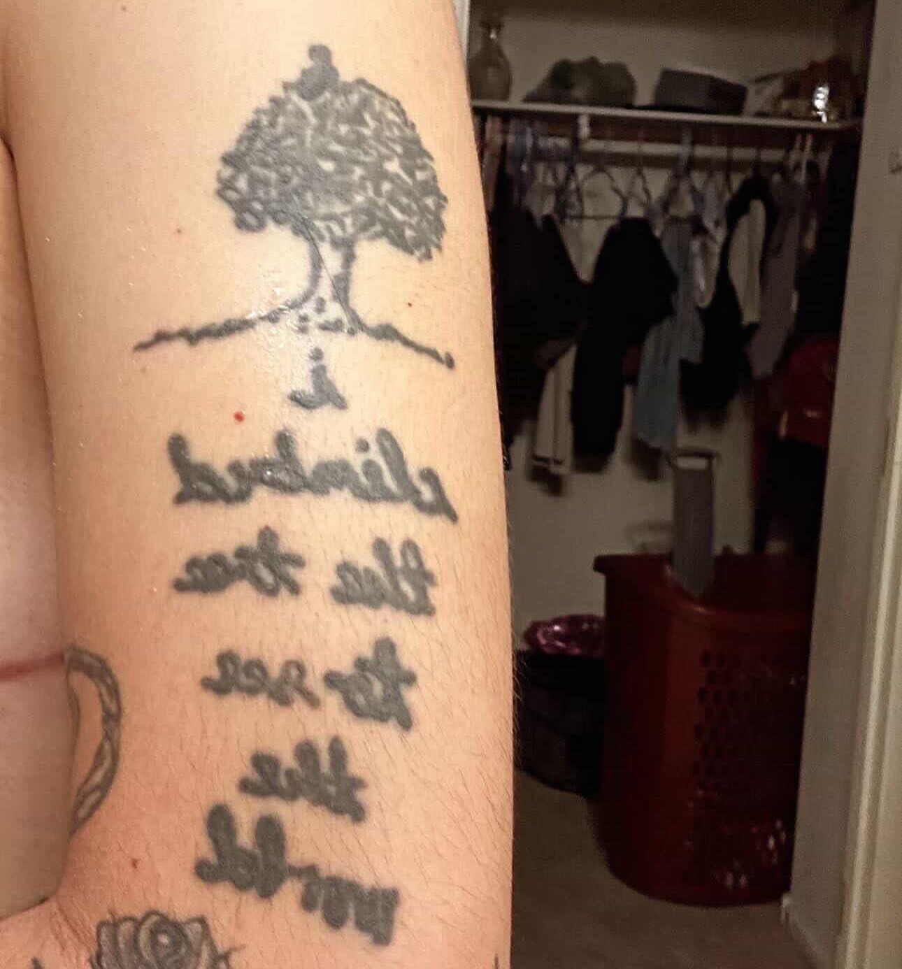Tree and Chinese characters black and grey tattoo on the forearm by Lee