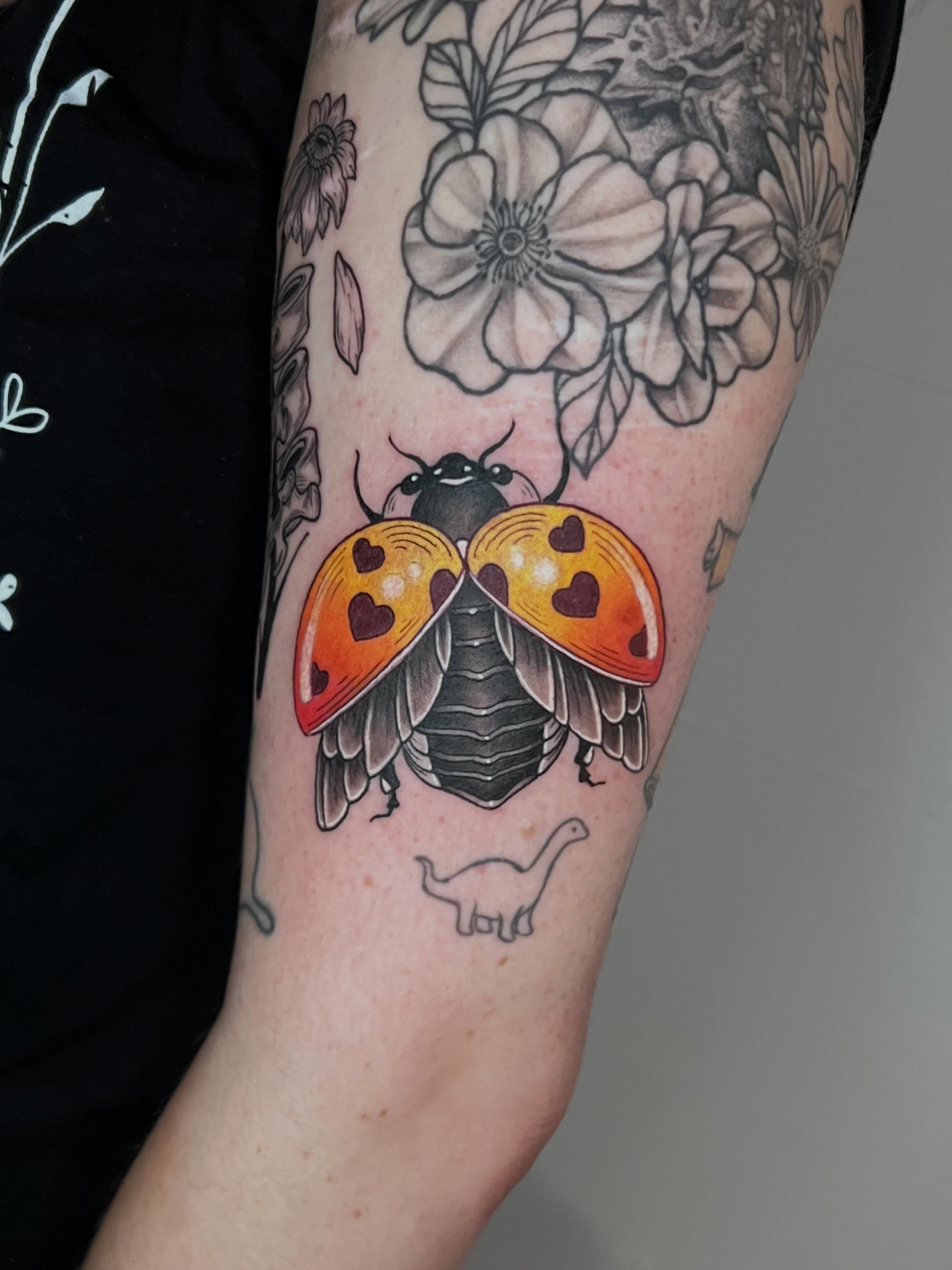 Ladybug trash polka tattoo on the forearm by Eoghann McGregor