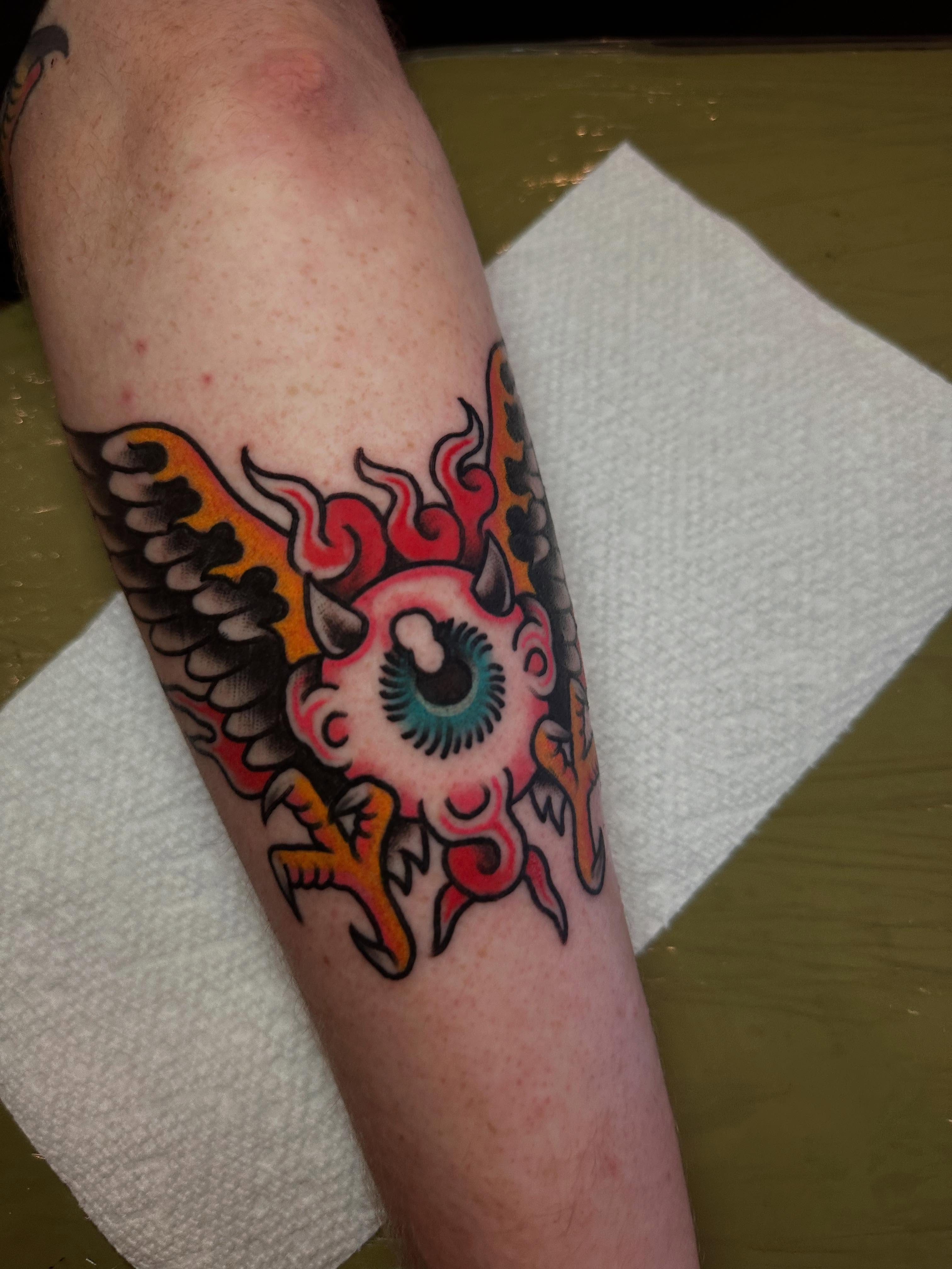Eye with wings American traditional tattoo on the forearm by Chris Bishop