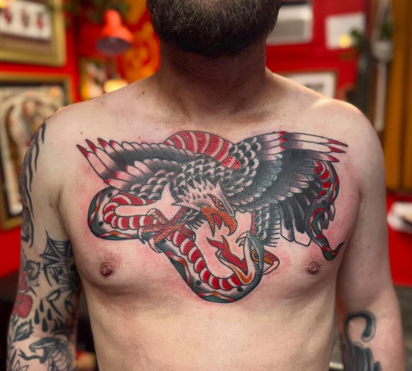Eagle and snake American traditional tattoo on the chest by Jacqui Rose