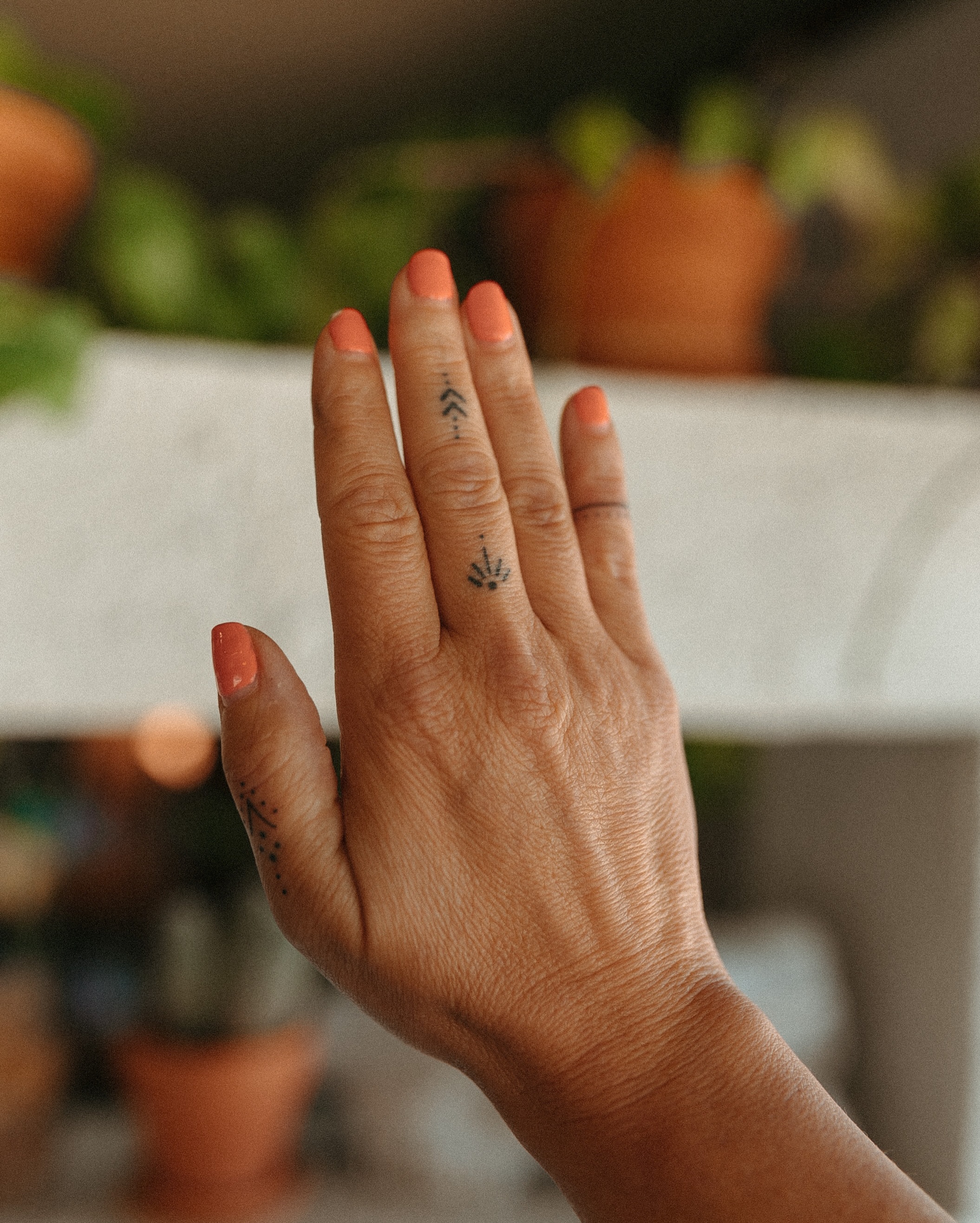 Arrows and leaf dotwork tattoo on the hand by Grace Wise - Handpoke Tattoos