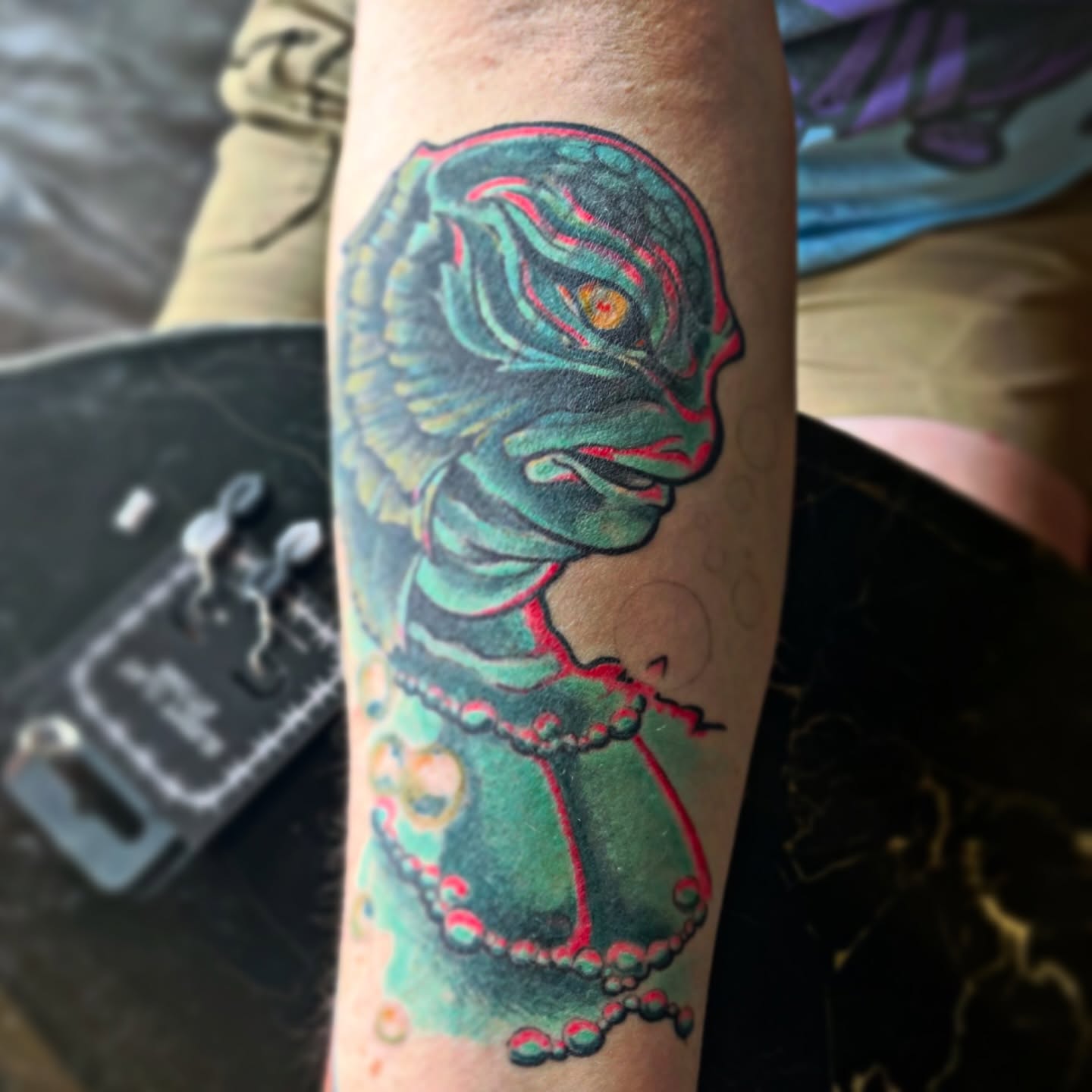 Alien in dress American traditional tattoo on the forearm by Lacey B, Portland, Oregon