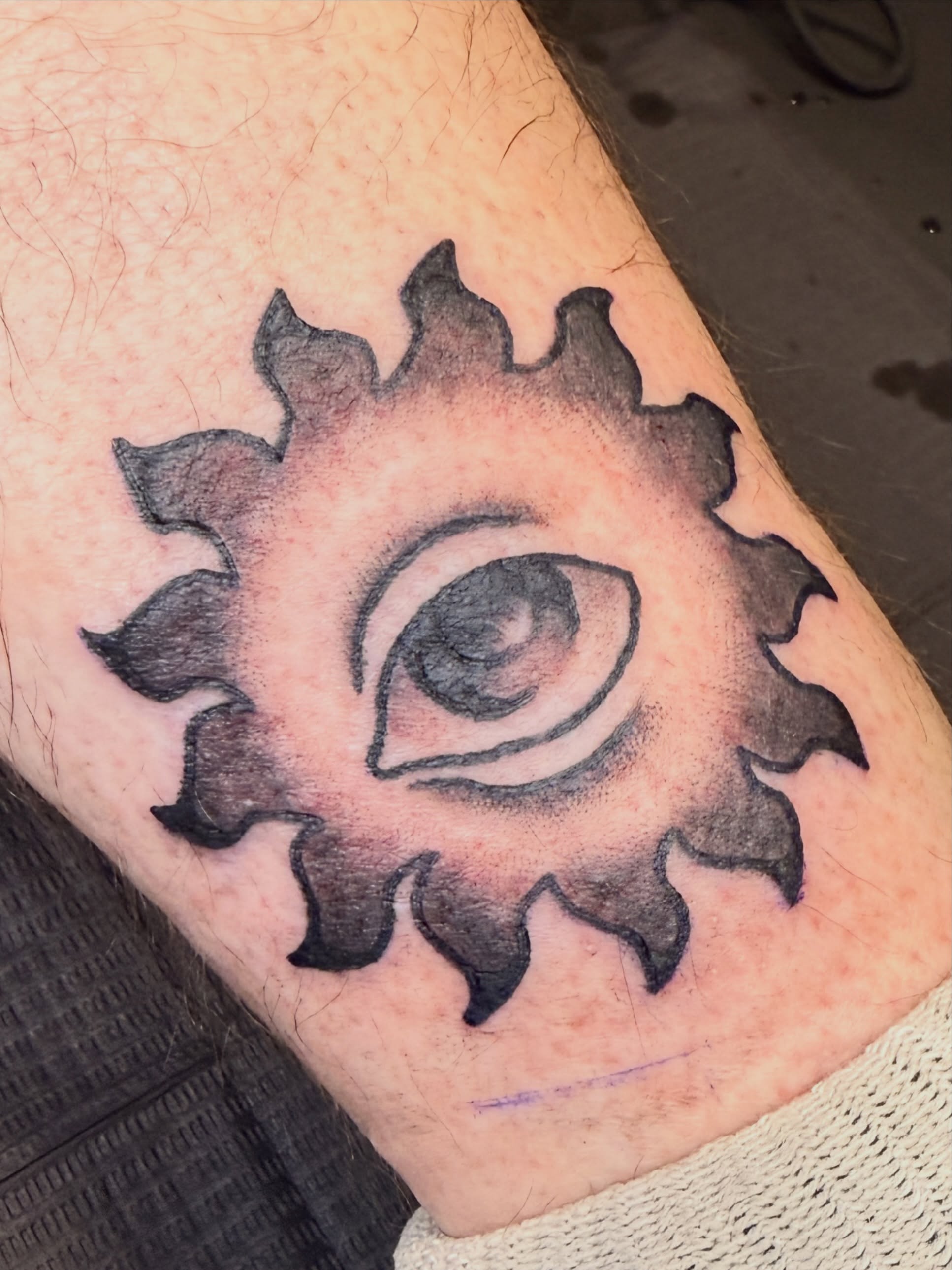 Eye with gear black and grey tattoo on the forearm by Penny D Tattoos