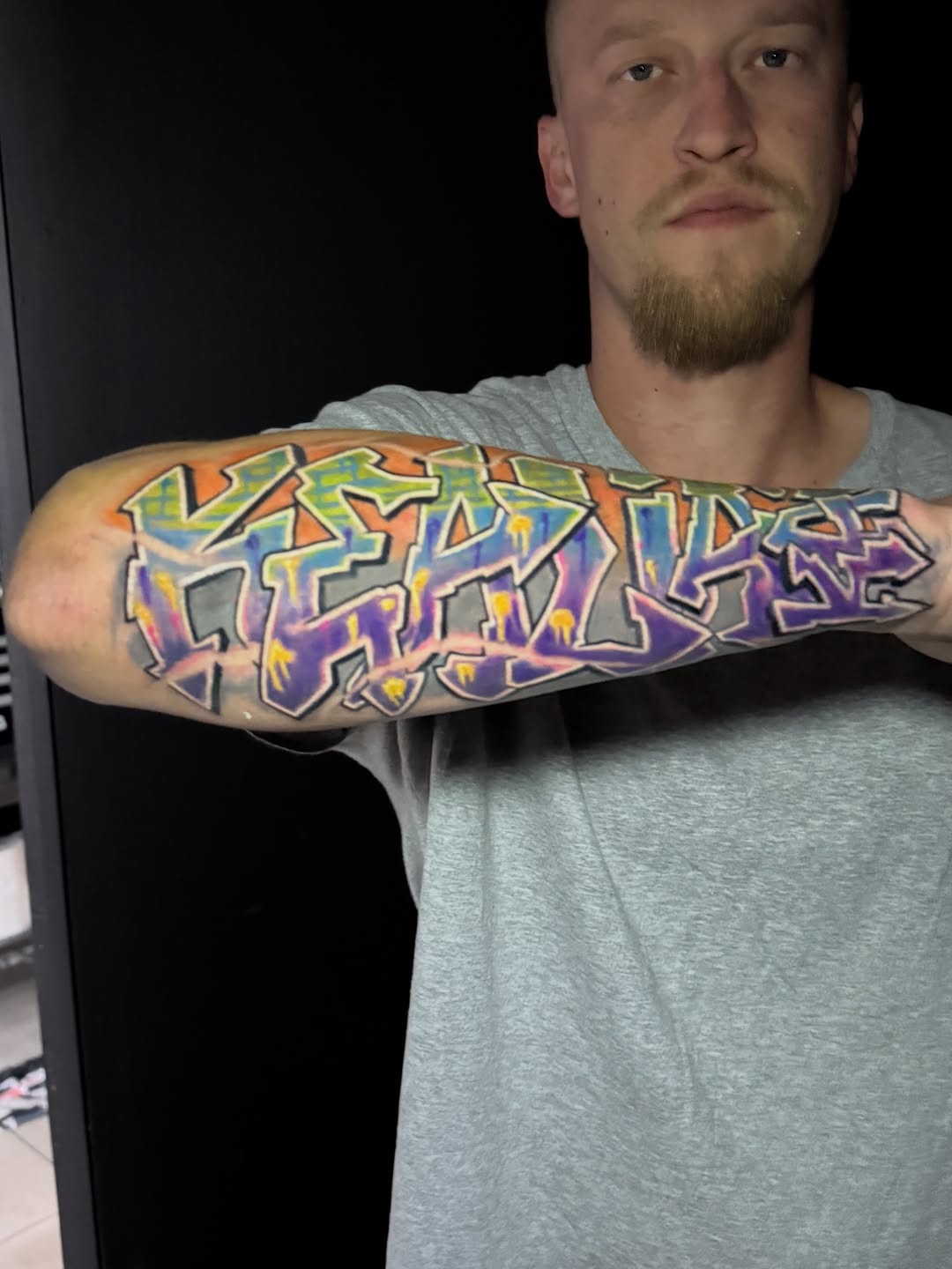 Graffiti lettering lettering tattoo on the forearm by Jarrod Gatzke